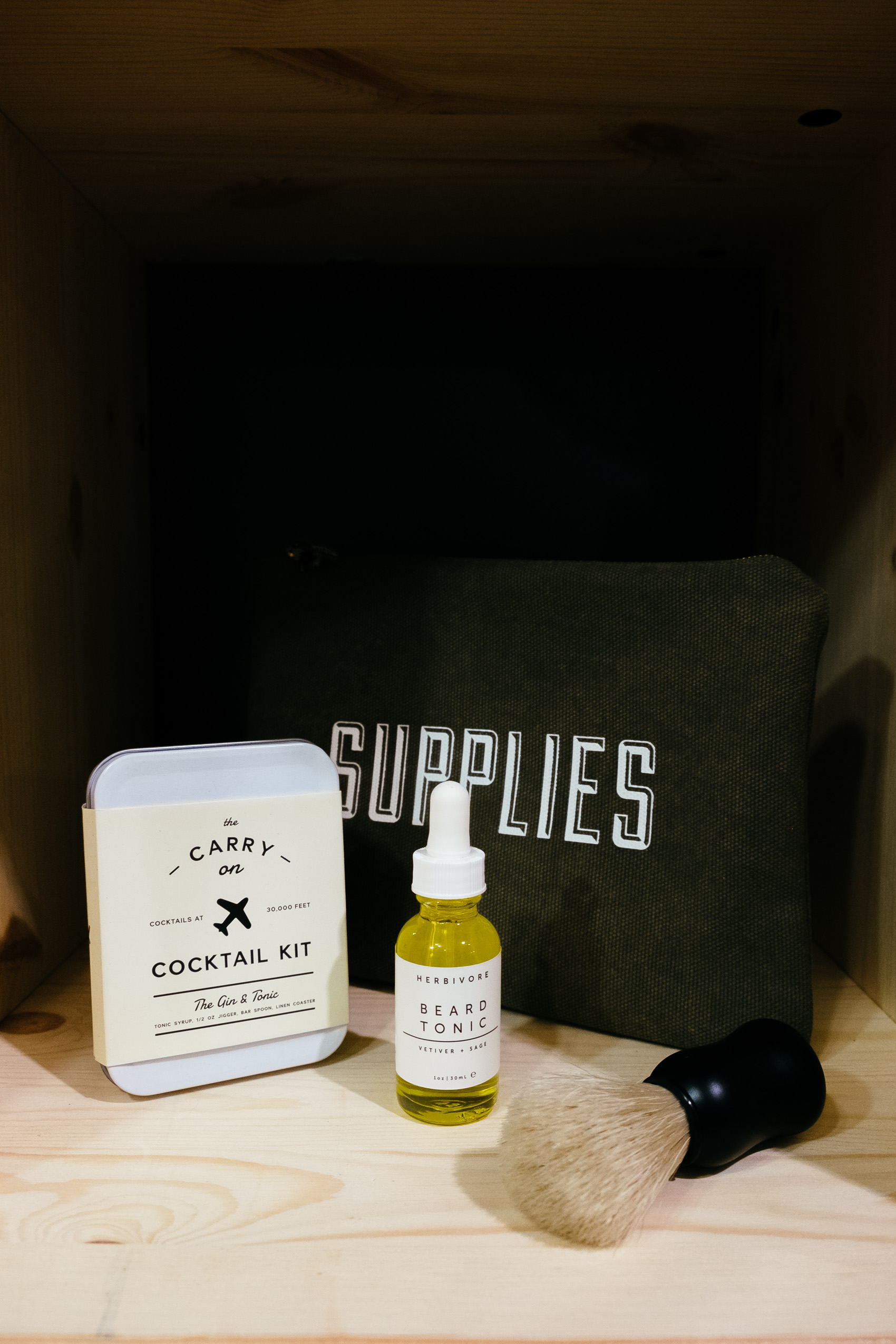 Cute gifts for him: SUPPLIES bag, Beard Tonic by Herbivore Botanicals, shaving brush and Gin & Tonic Carry On Cocktail Kit