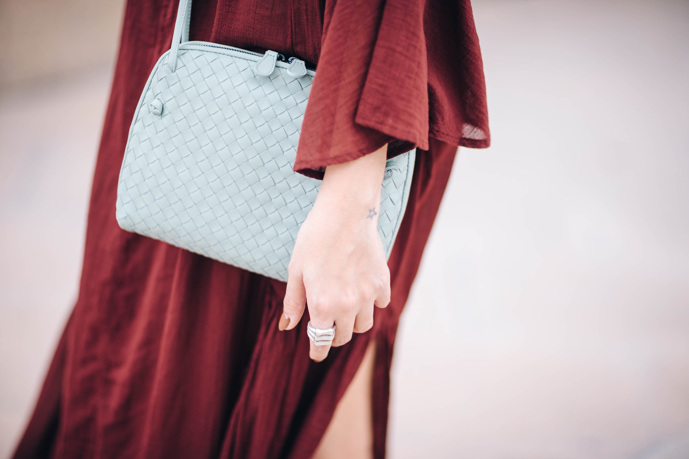 A Constellation blogger Maristella Gonzalez wears the Bottega Veneta small leather Intrecciato bag in sage pale mint green