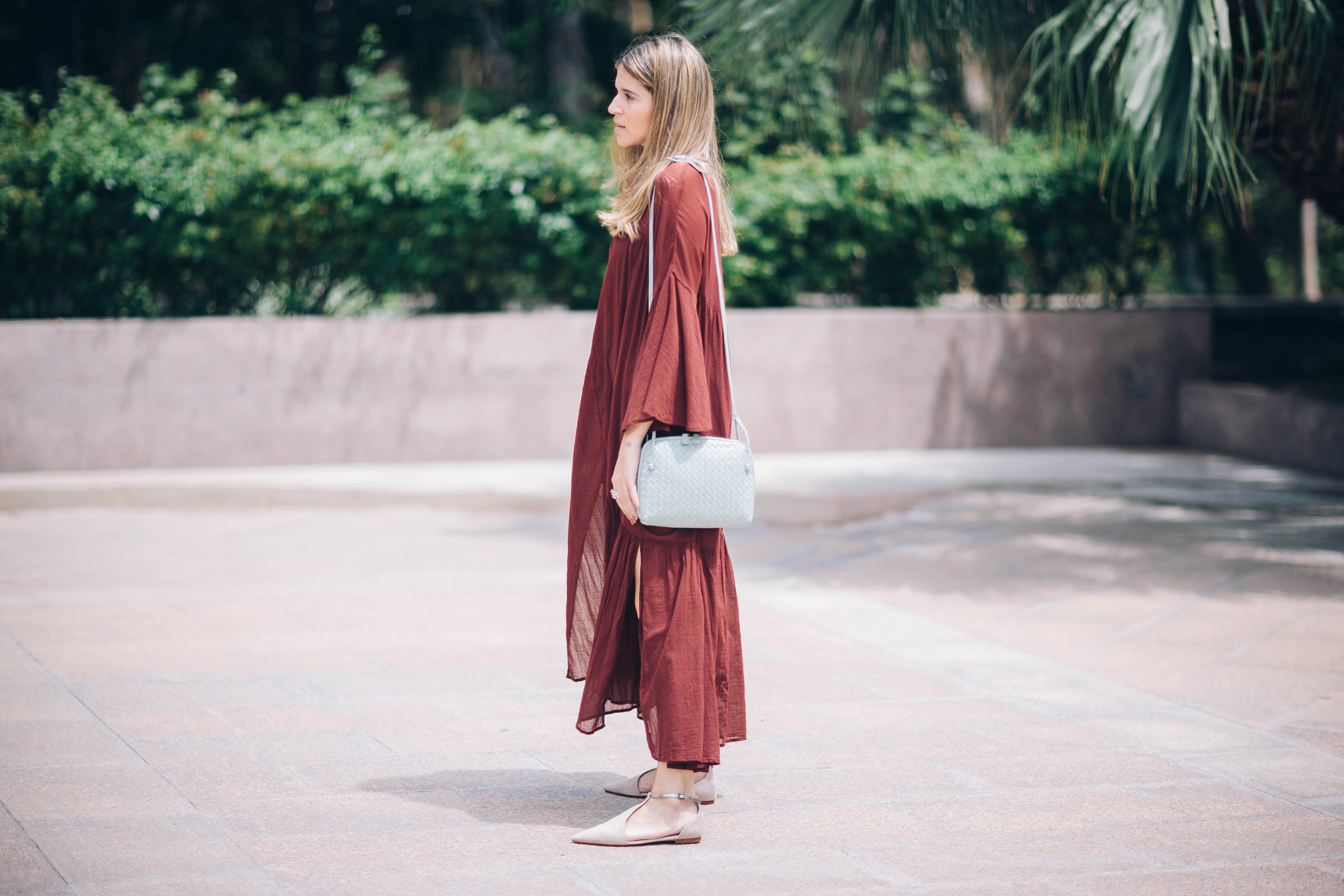 Latina blogger Maristella Gonzalez of A Constellation wears an H&M maxi dress in Marsala with a small leather Bottega Veneta bag and nude flats