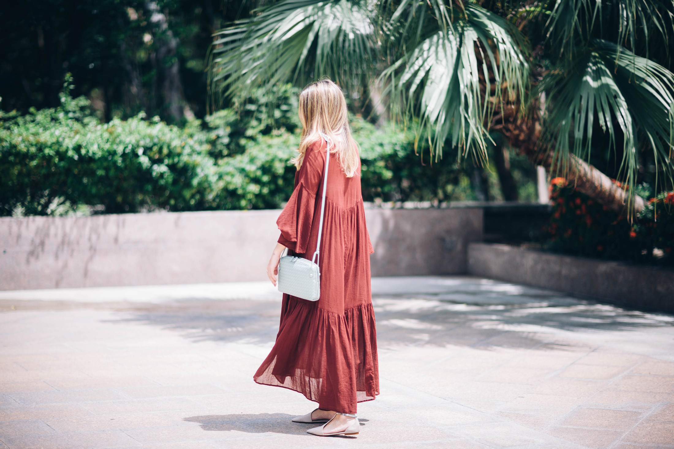 A Constellation blogger Maristella wears a bohemian look with a burgundy maxi dress and Bottega Veneta shoulder bag