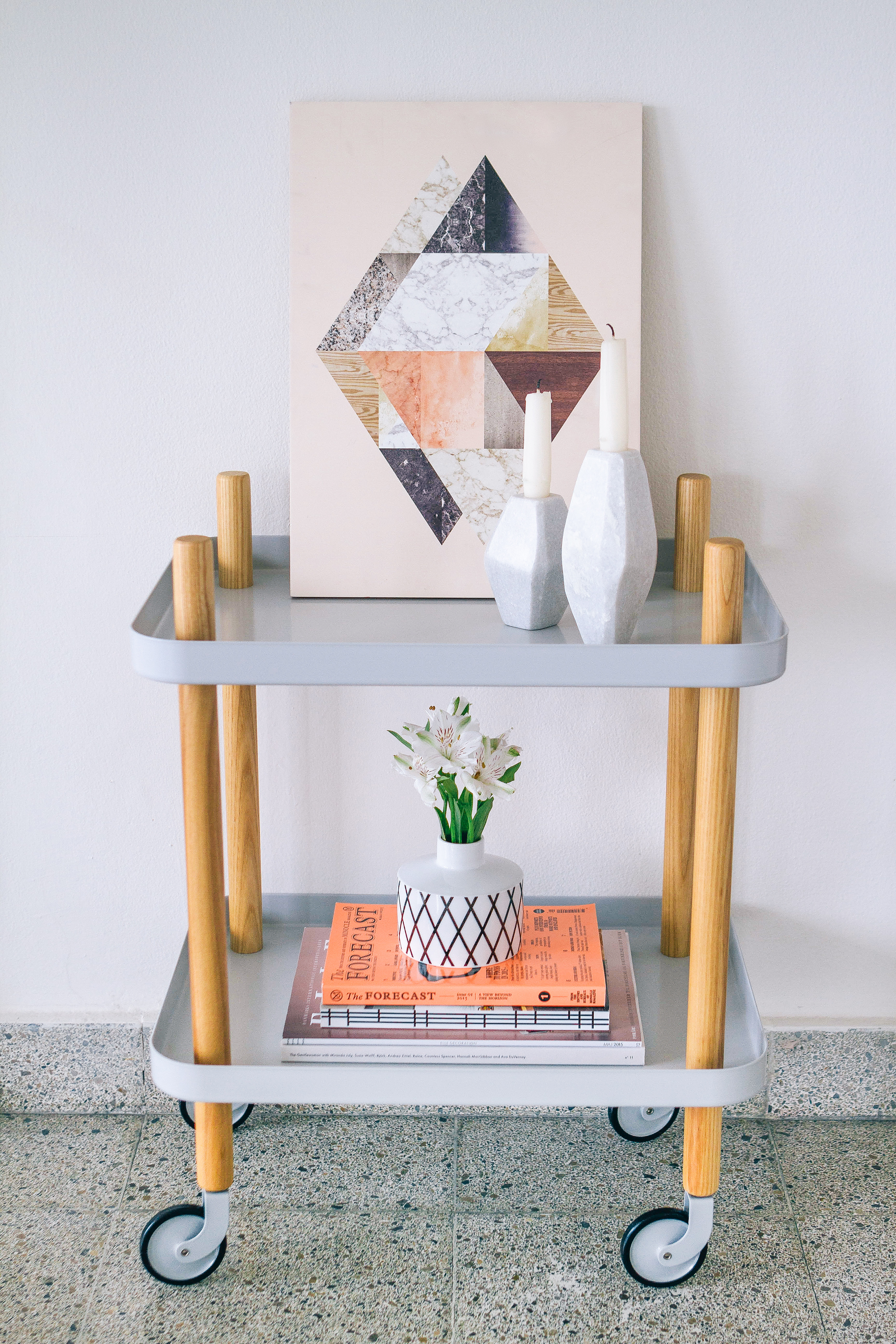Bar cart styling with magazines, flowers and candles