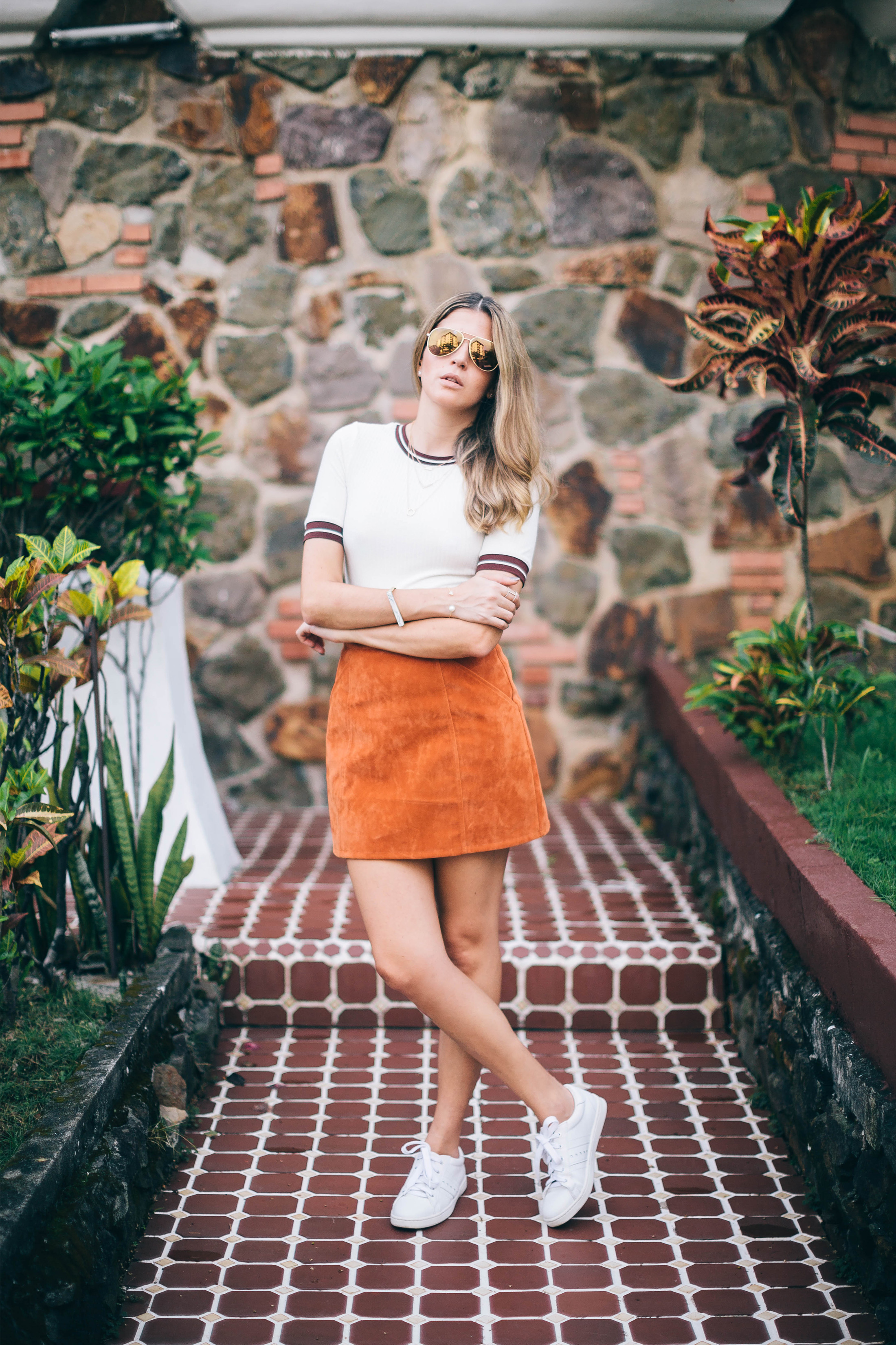 Maristella wears a suede skirt by Minkpink with H&M top and Saint Laurent aviators