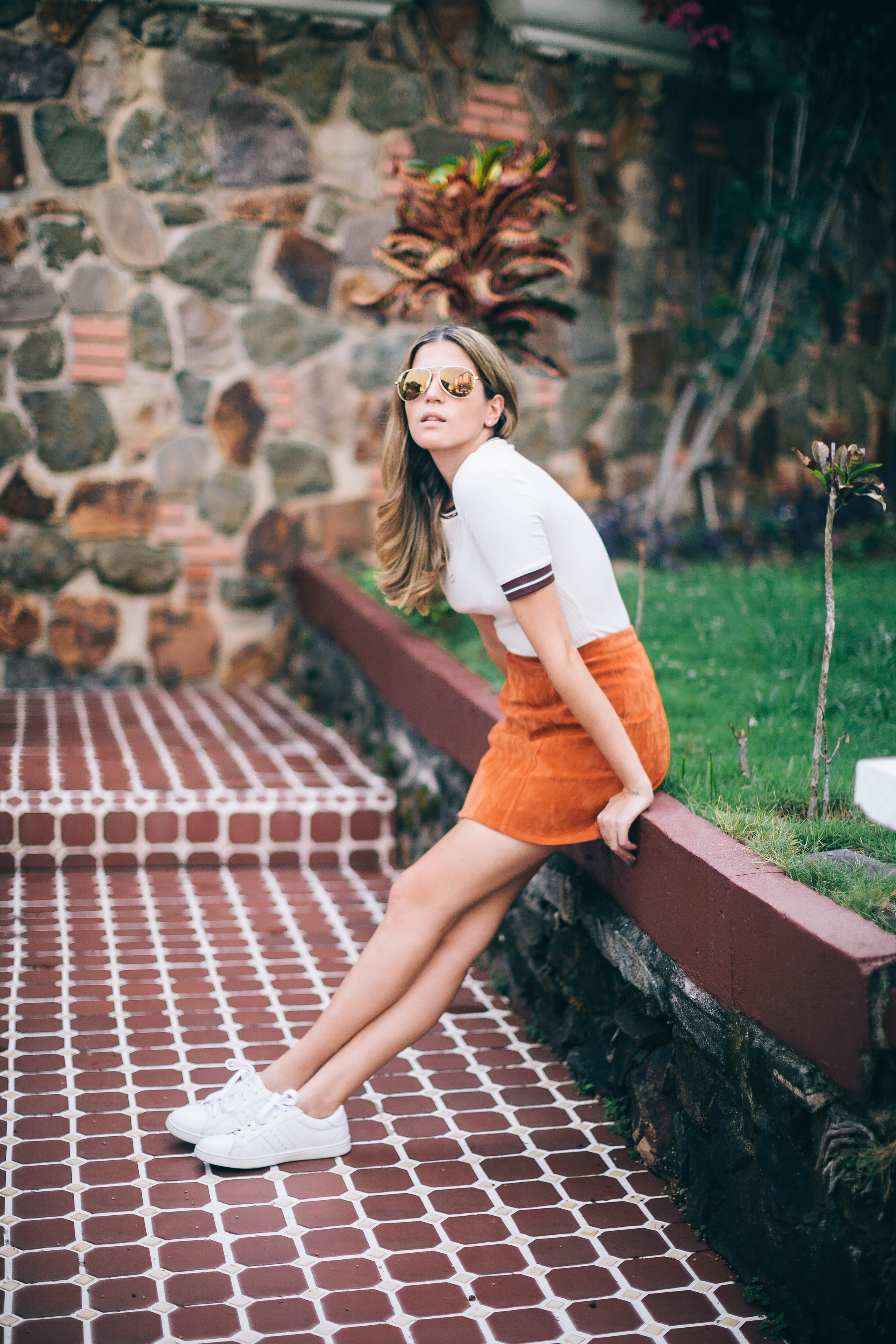 Blogger Maristella in Panama wearing an A Line skirt with white Adidas style sneakers