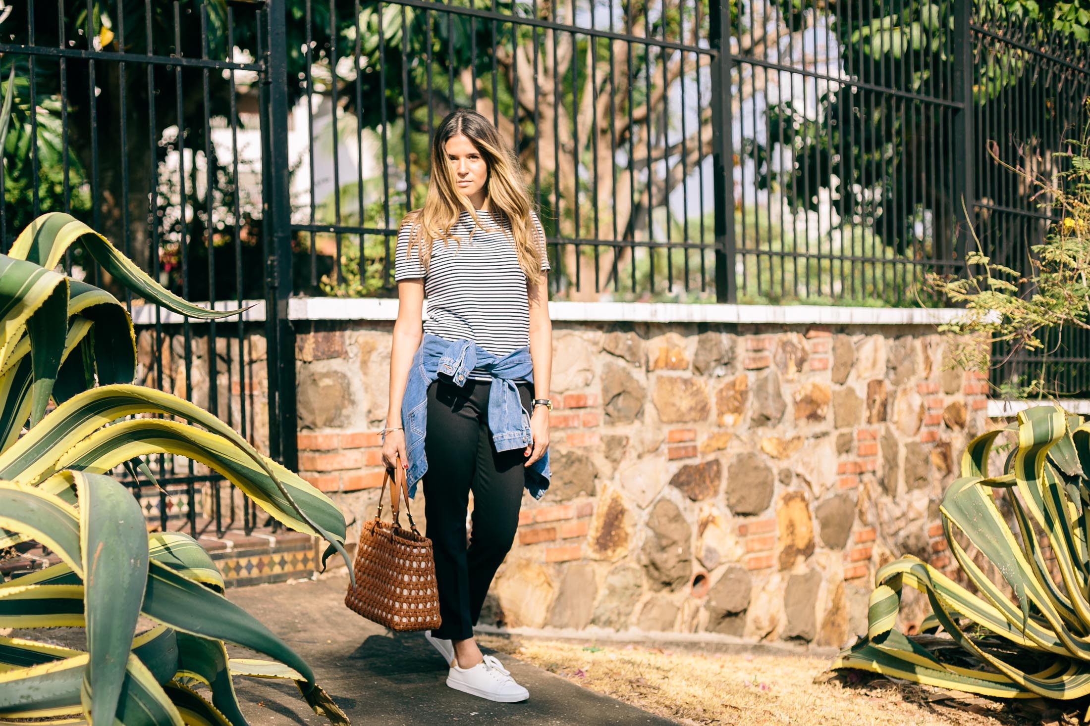 Blogger Maristella Gonzalez wears a timeless combination of stripes, denim, leather, black and white.