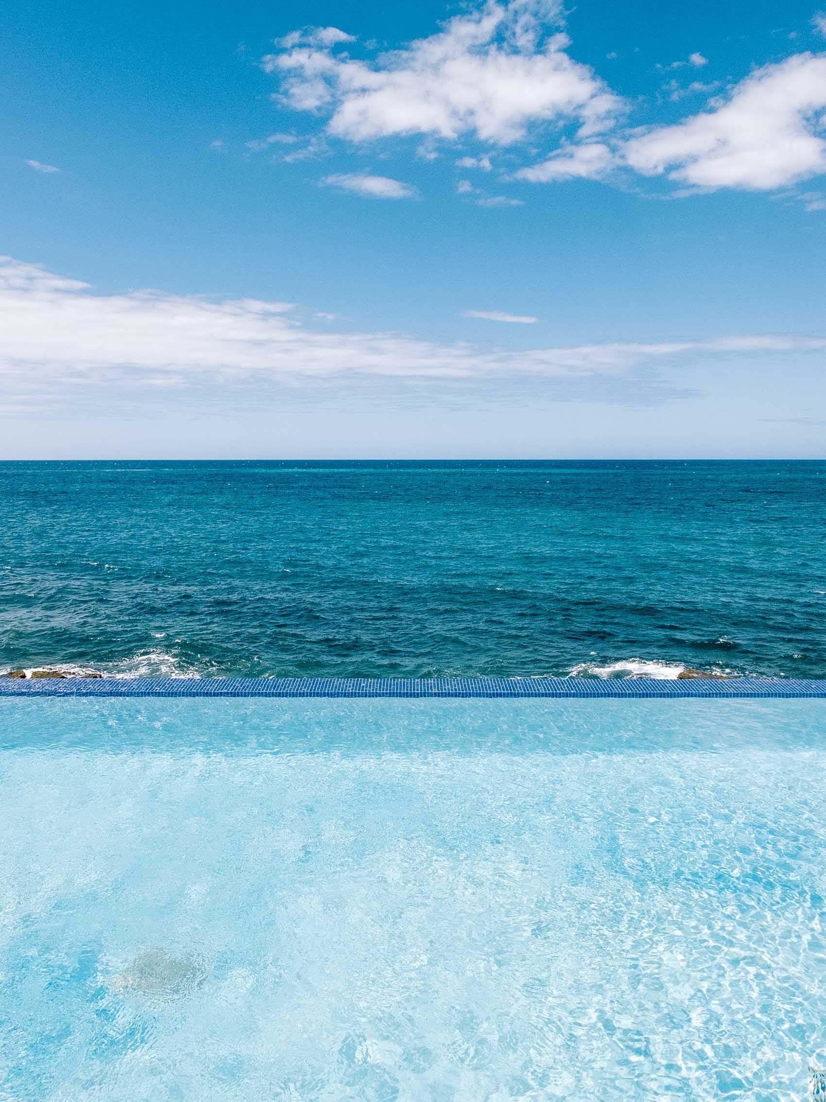 Infinity pool overlooking the Caribbean ocean at the Condado Vanderbilt hotel in San Juan, Puerto Rico