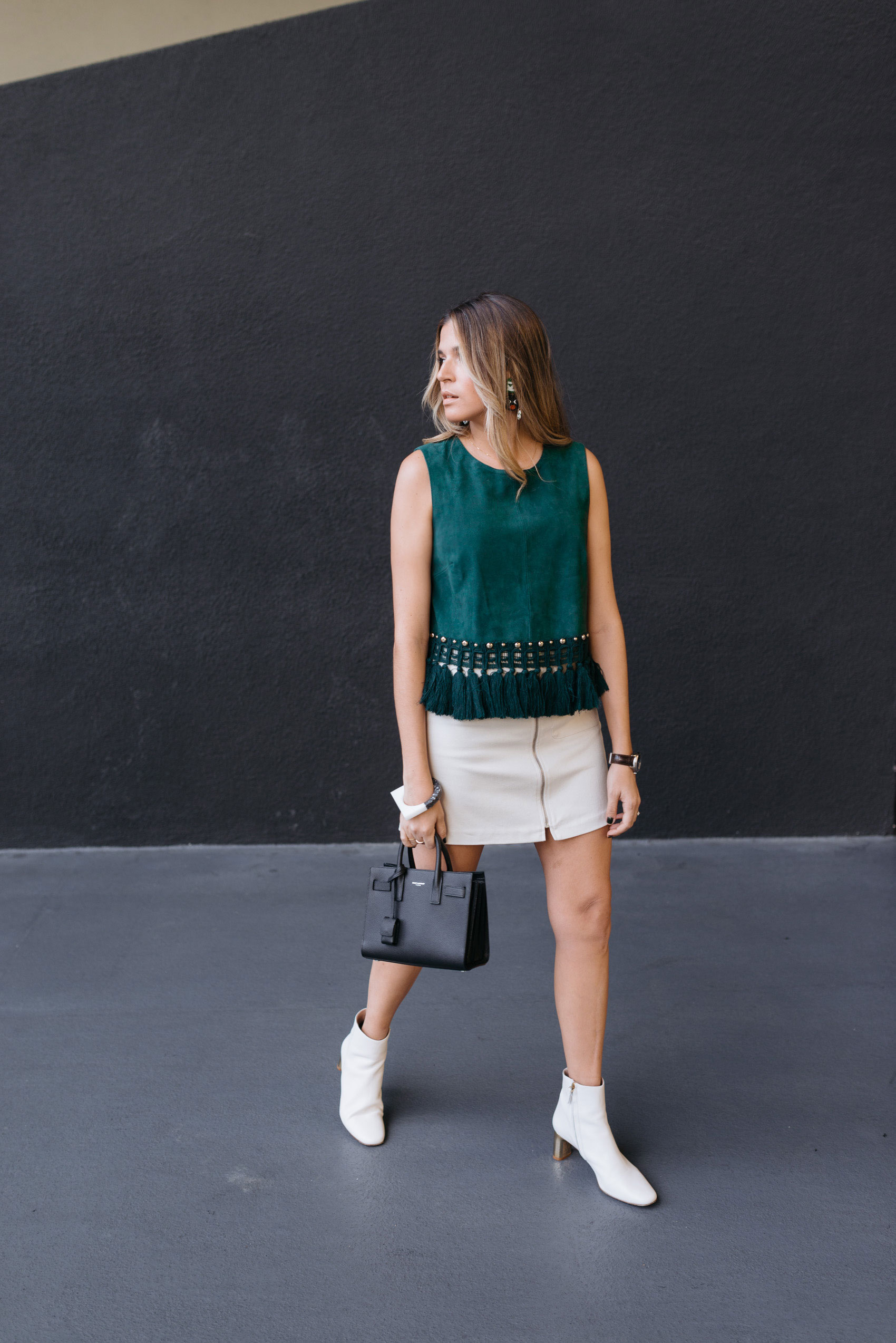 Blogger Maristella in Los Angeles at The Line Hotel, wearing a green suede top and white ankle boots from Uterqüe, skirt from Zara, Sac De Jour from Saint Laurent