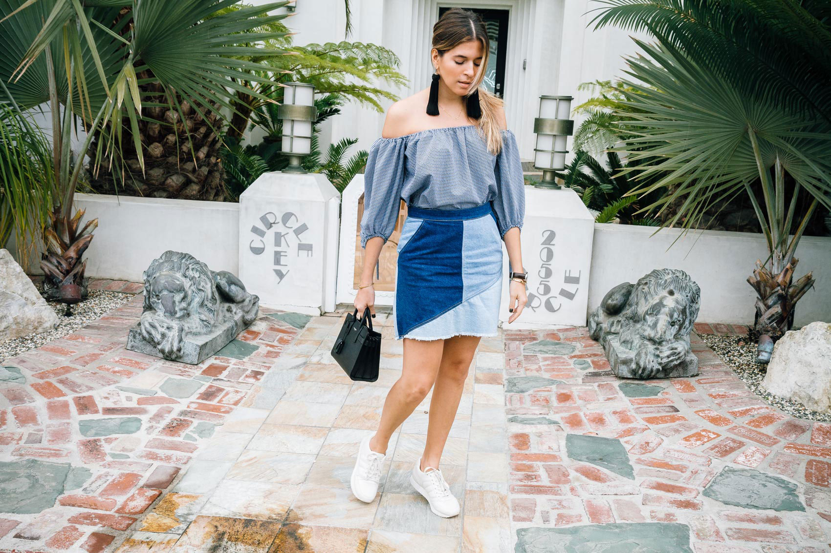 Maristella shows off how to wear sneakers with a skirt for a chic yet casual outfit
