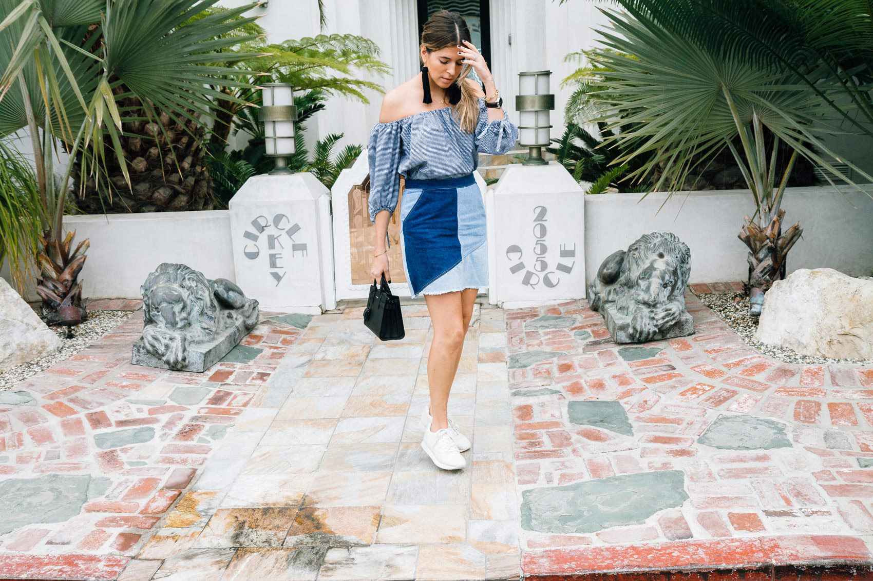 Blogger Maristella in Los Angeles wearing gingham and patchwork denim with white sneakers and a YSL bag