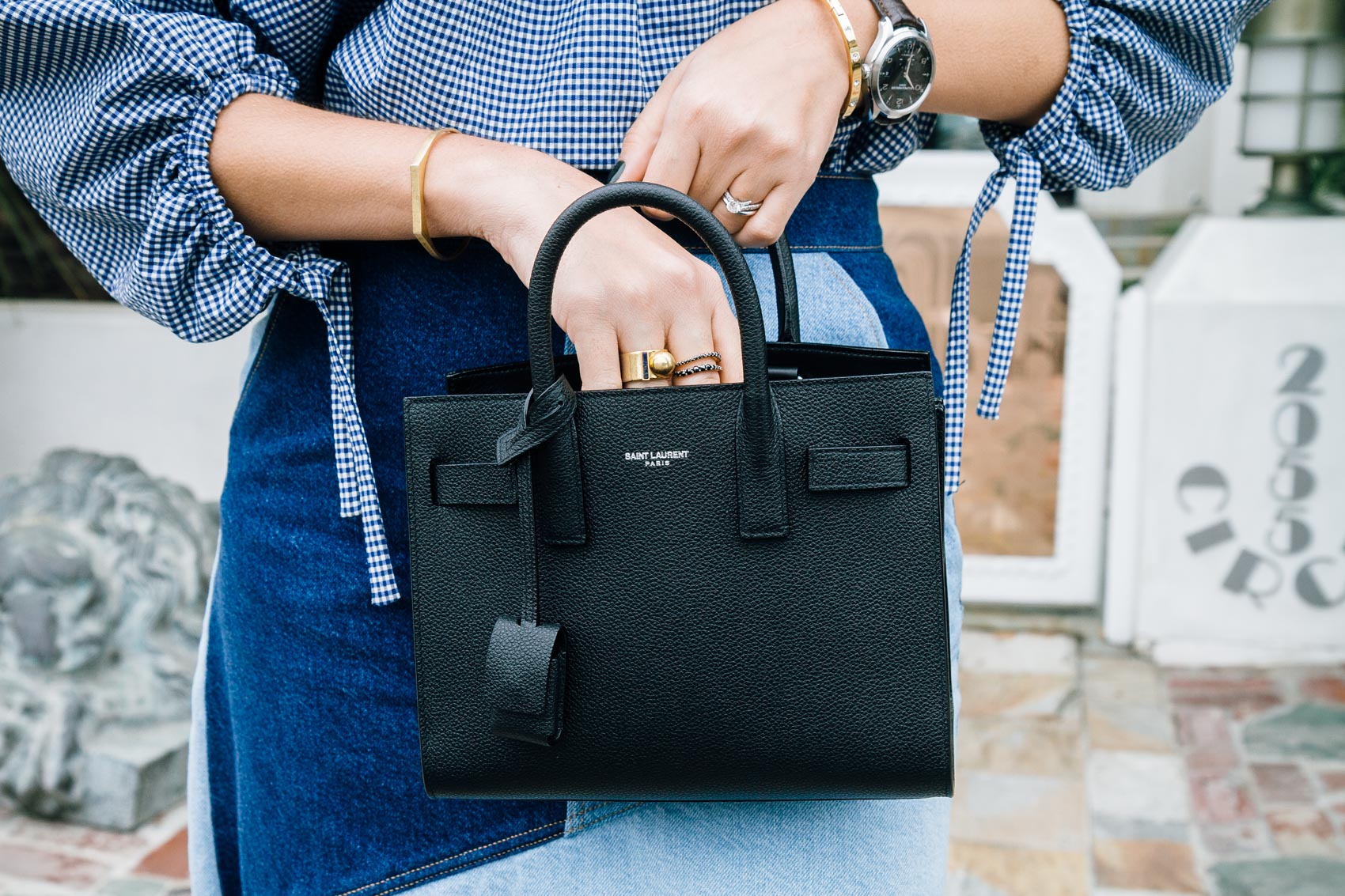 Maristella wears a bracelet and ring from Madewell and a bracelet from Kate Spade, YSL nano Sac De Jour bag in black