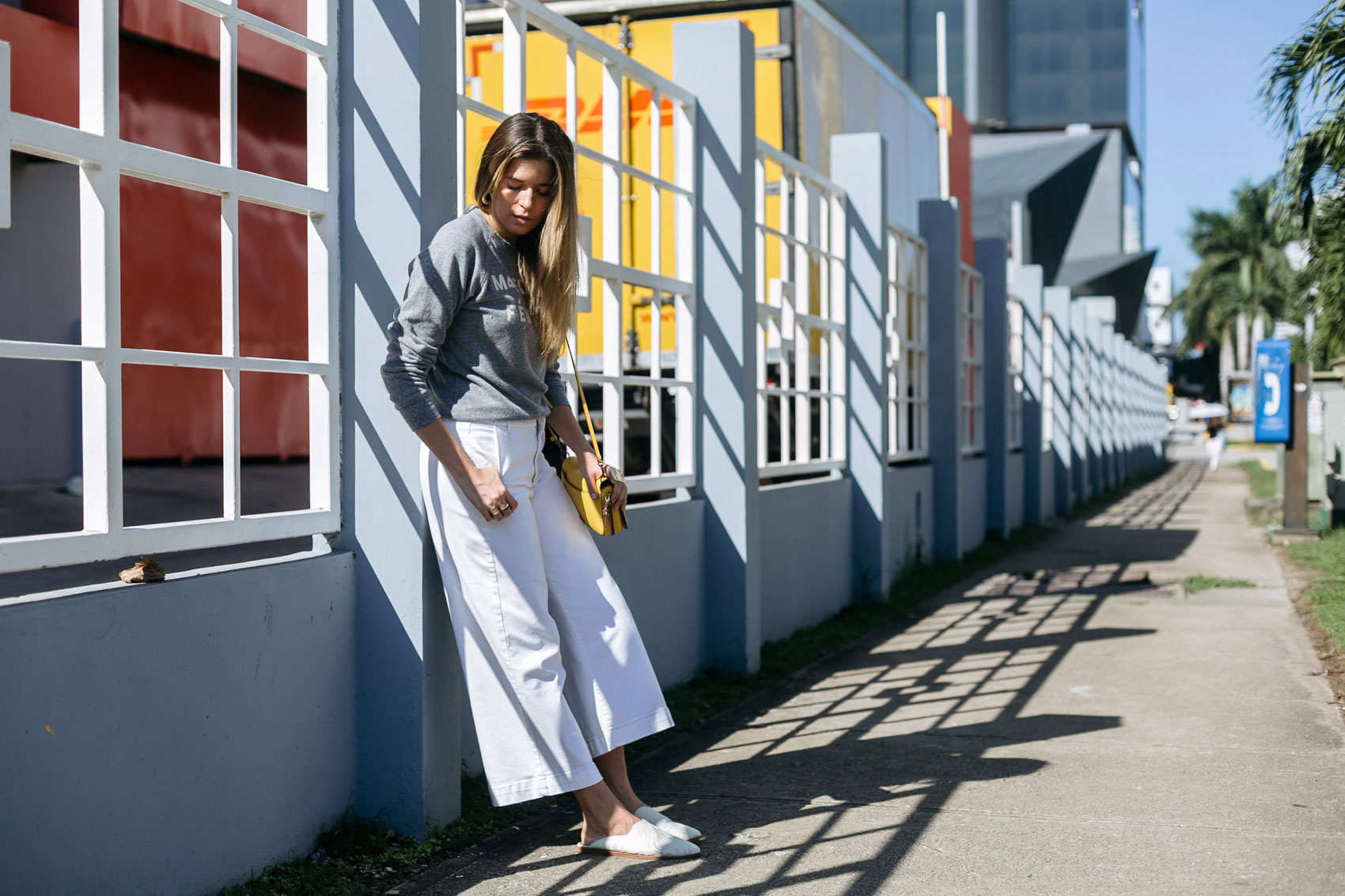 Maristella wearing Dolce Vita mule slide flat shoes with wide leg cropped denim and Clare V top