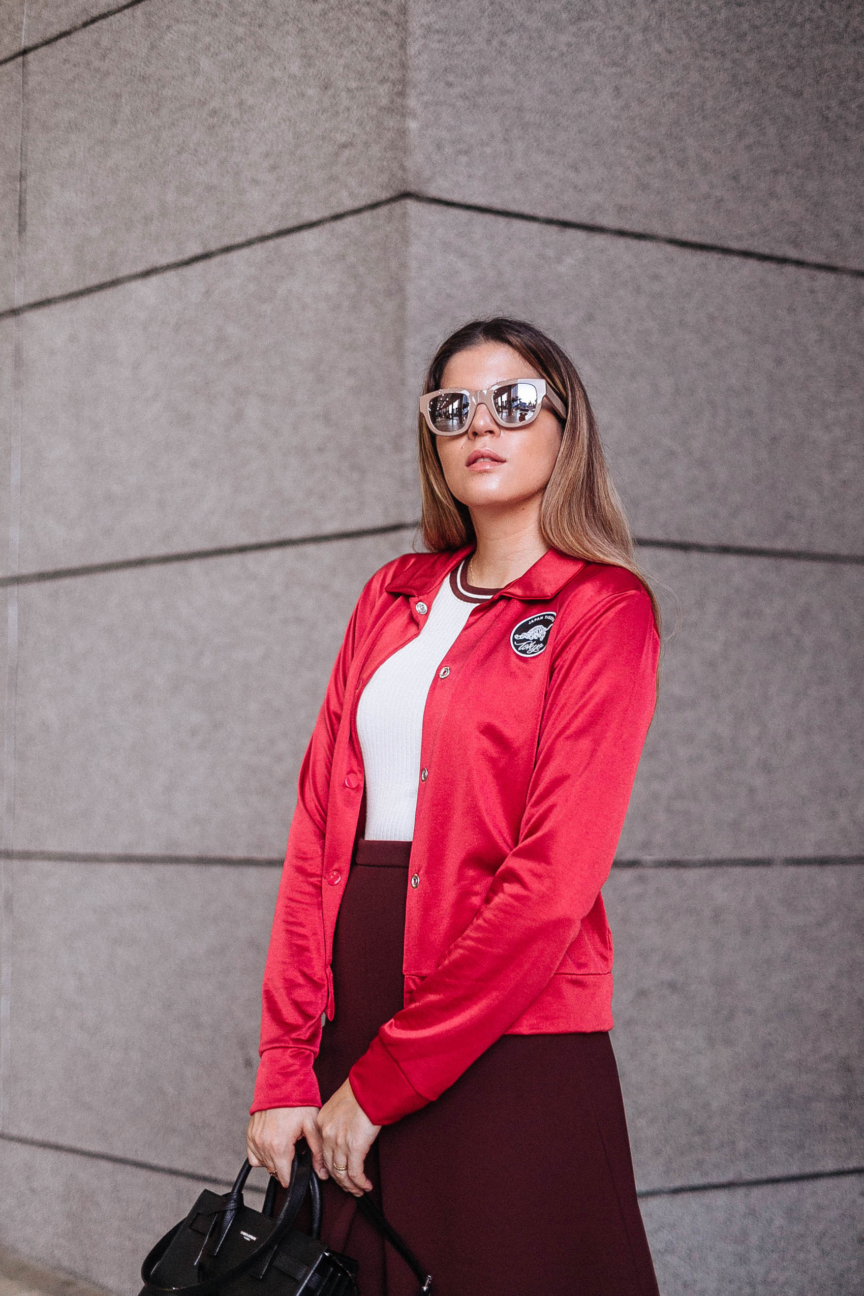 Maristella wearing Acne Studios mirrored sunglasses, Zara red bomber jacket, H&M top and skirt, Saint Laurent nano Sac de Jour bag