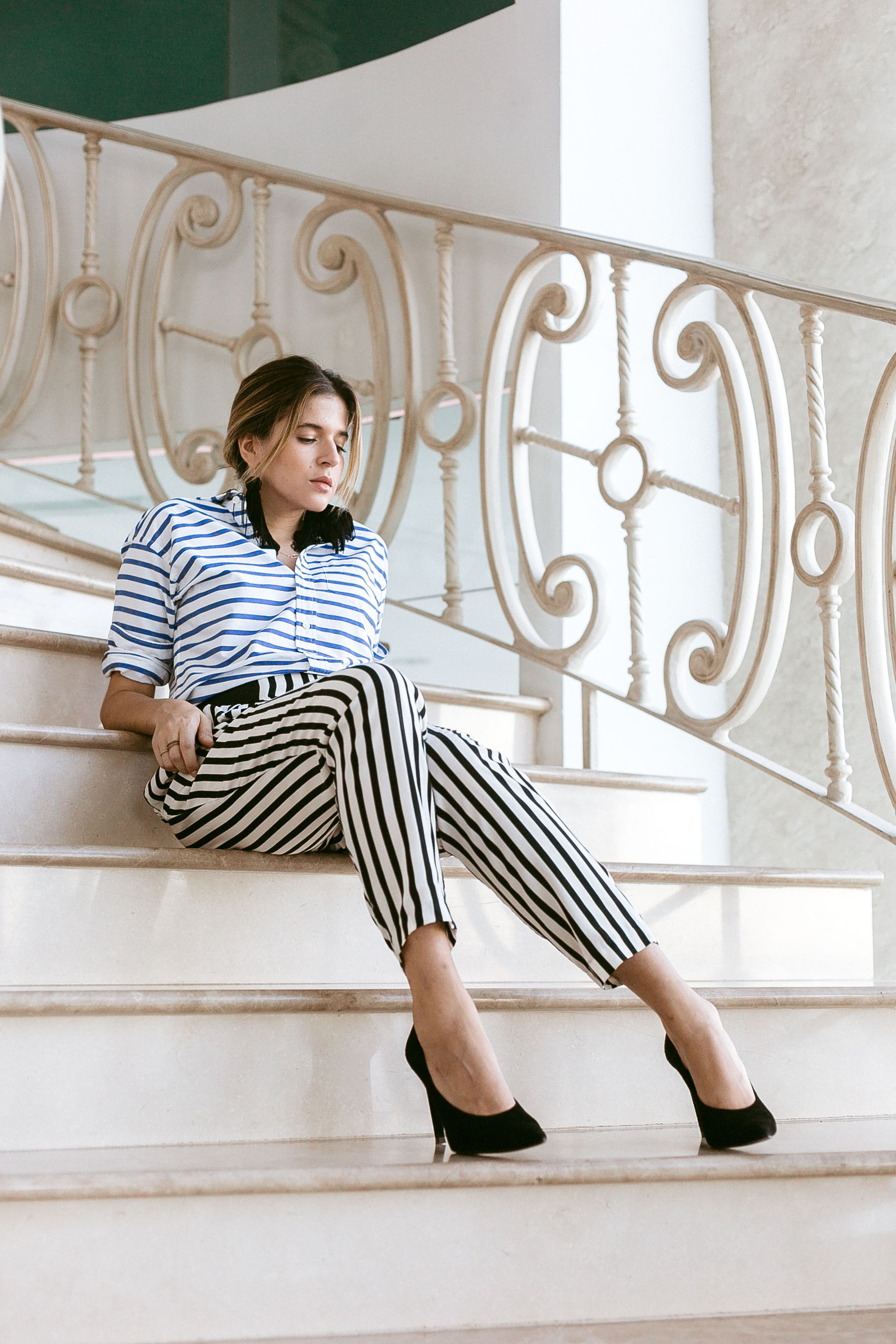 Maristella wears a stripe on stripe look of the day with tassel earrings and black pumps