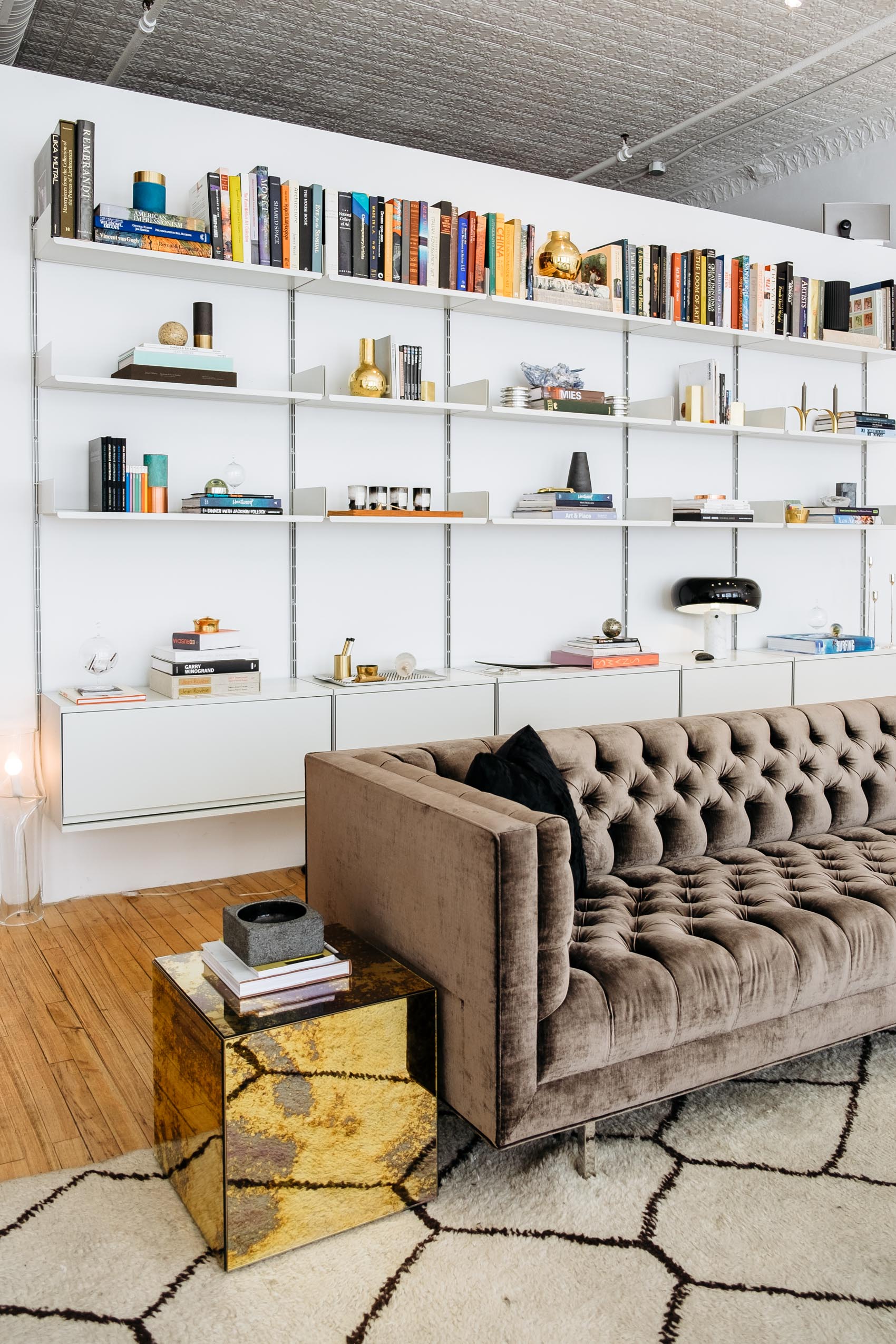 Livingroom bookcase and tufted velvet sofa at The Apartment by The Line in New York