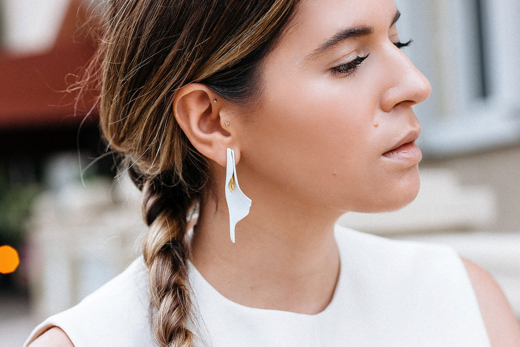 Maristella wears Calla lily earrings from Purificacion Garcia, floral statement jewelry, minimalist jewelry, sculptural earrings jewelry