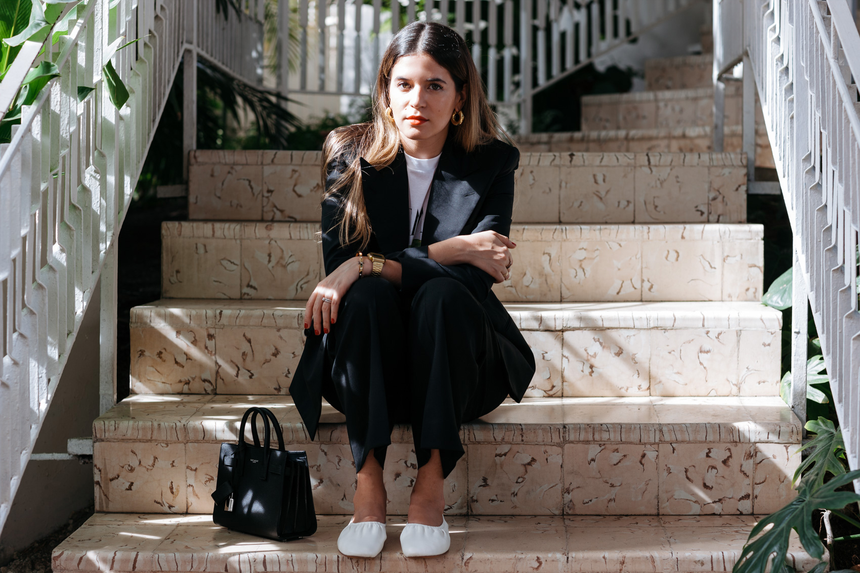 Blogger Maristella in a black suit by Polo Ralph Lauren with T-shirt, ballerina flats and mini bag