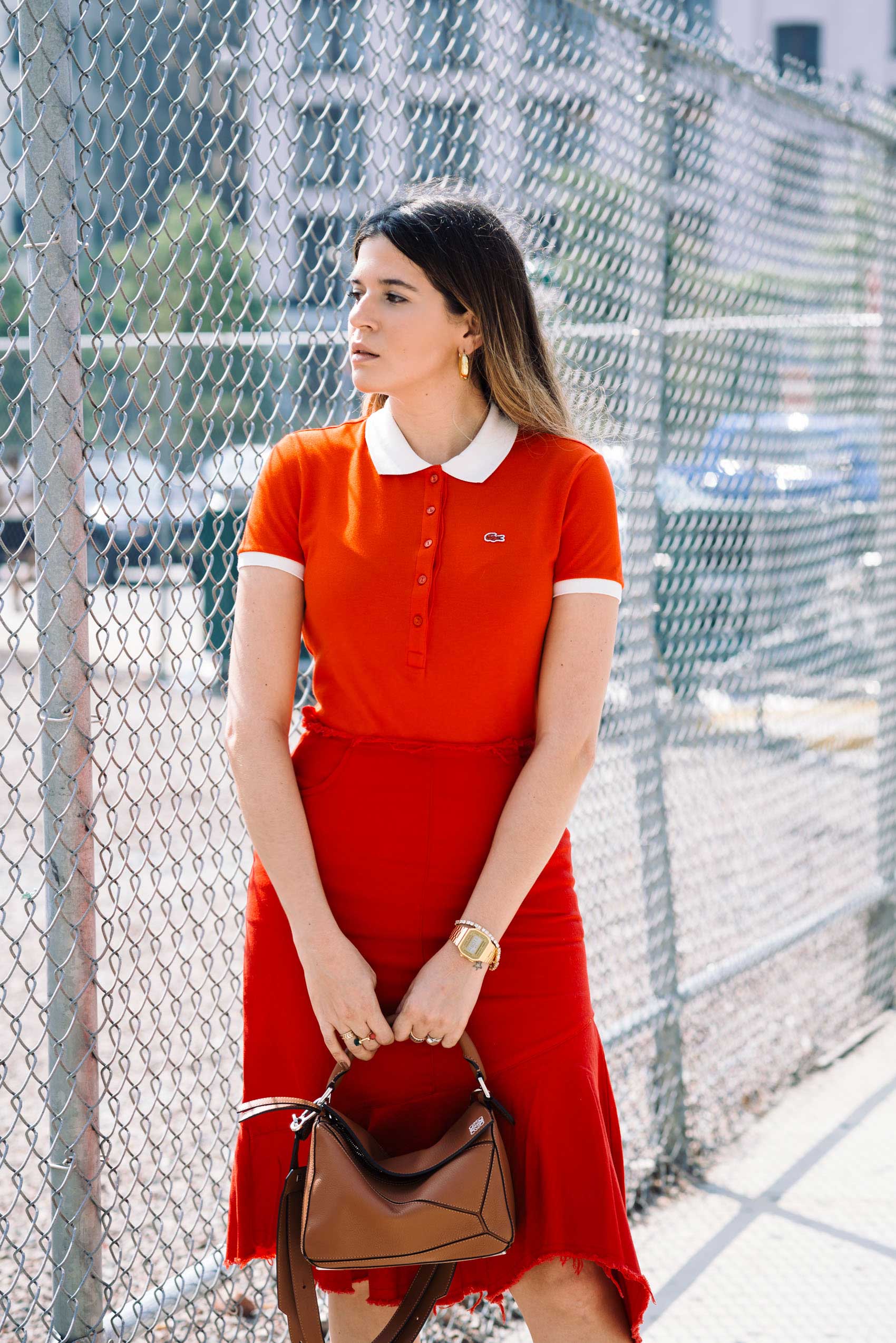 Maristella wearing an all red monochrome outfit with a Lacoste polo shirt and ruffle skirt from Style Mafia
