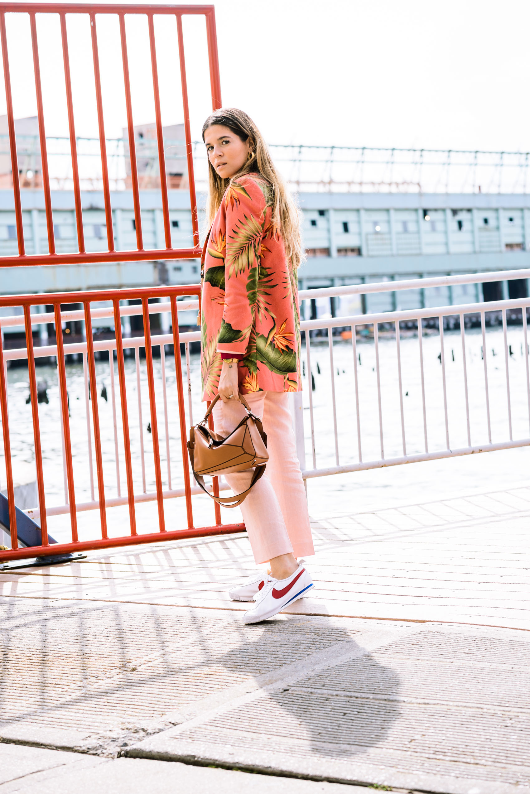 Maristella at NYFW wearing a pink pantsuit by Colombian label Atelier Crump with a tropical Heliconia print coat