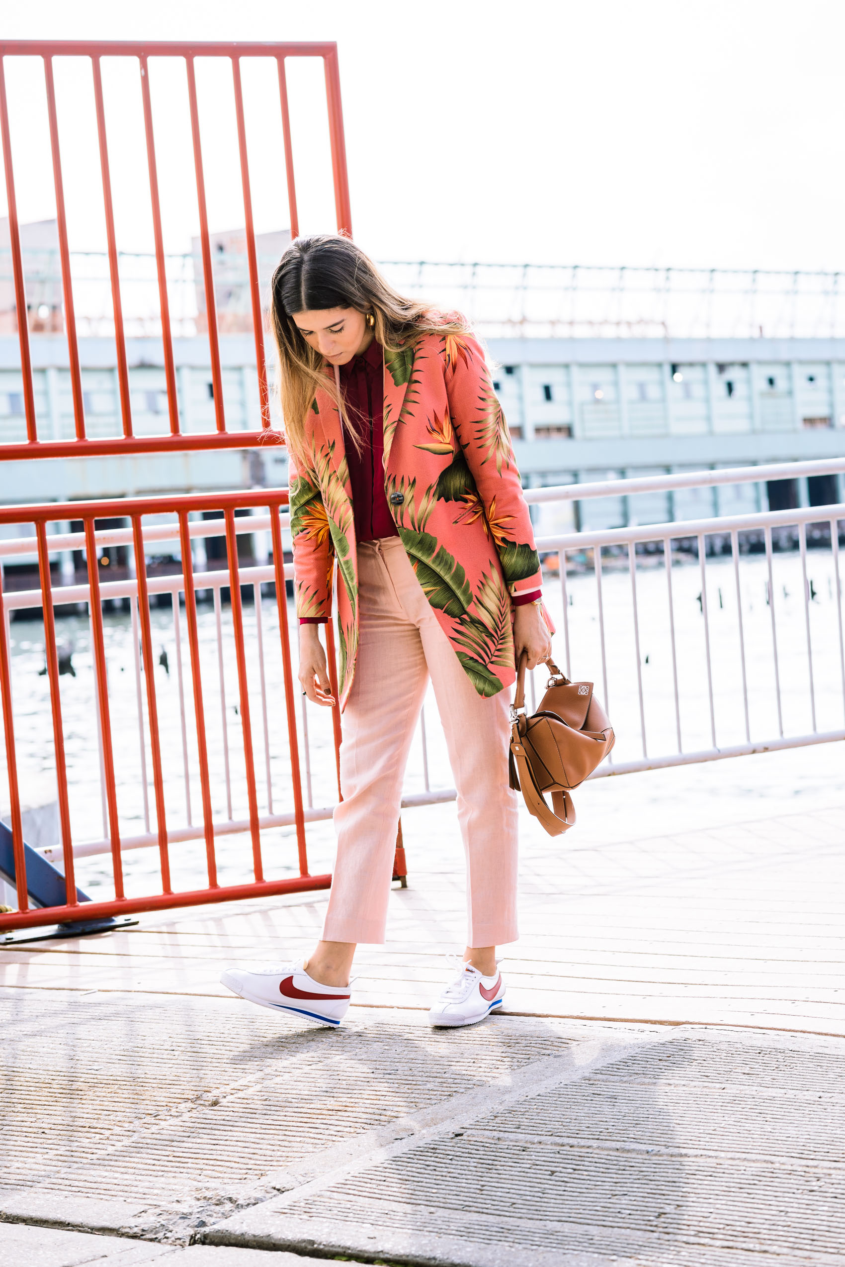 Blogger Maristella's NYFW look with Atelier Crump floral printed blazer and suit, Nike Cortez sneakers and Loewe Puzzle bag