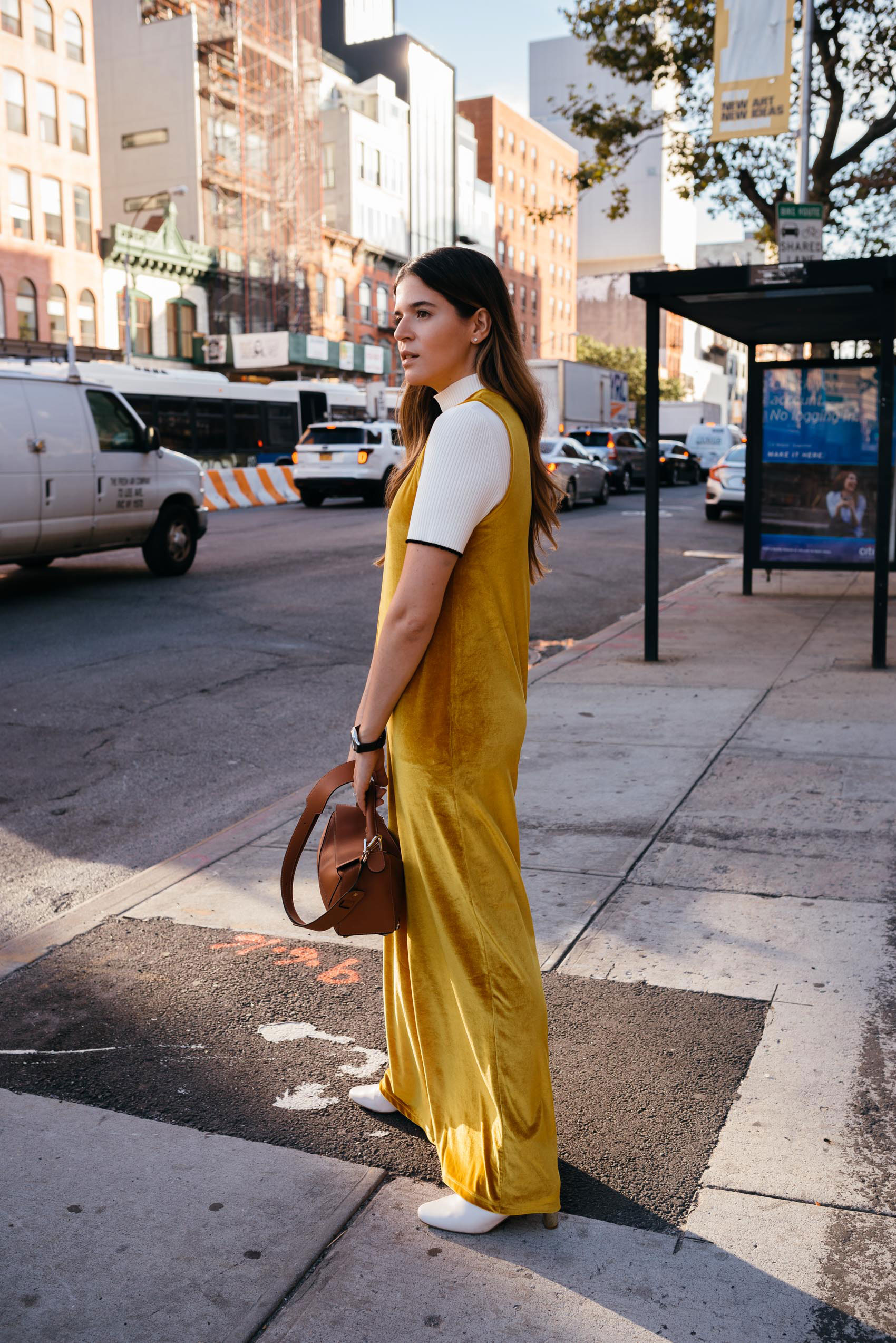 Maristella in New York wearing a velver gold jumpsuit and knit top from Zara, Uterqüe boots and Loewe Puzzle bag
