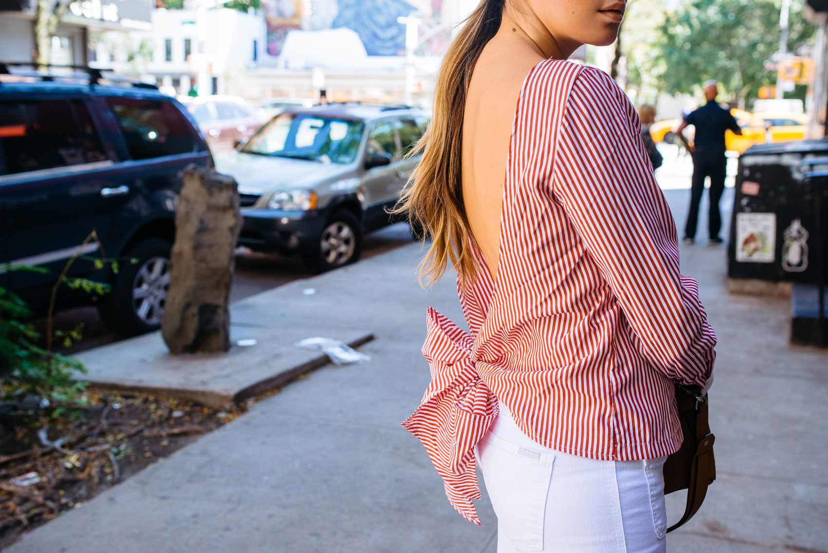 Maristella wears a red striped blouse with an open plunging back while in New York