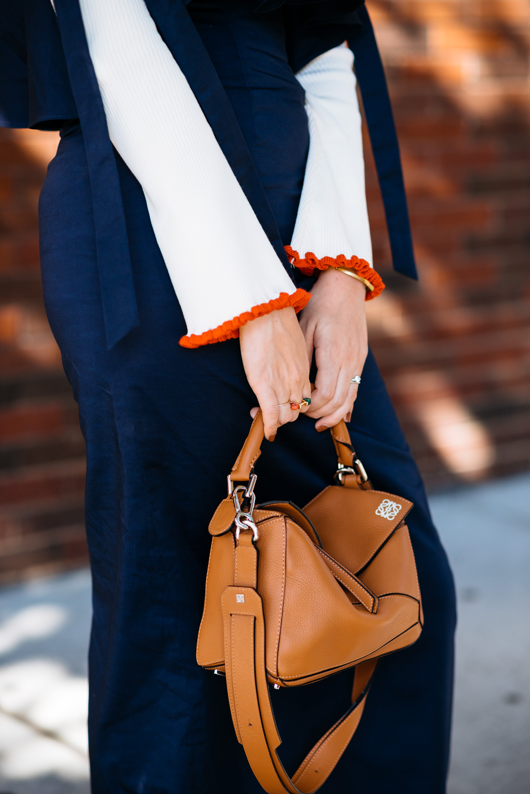 Flare sleeve details and Loewe puzzle bag in tan leather
