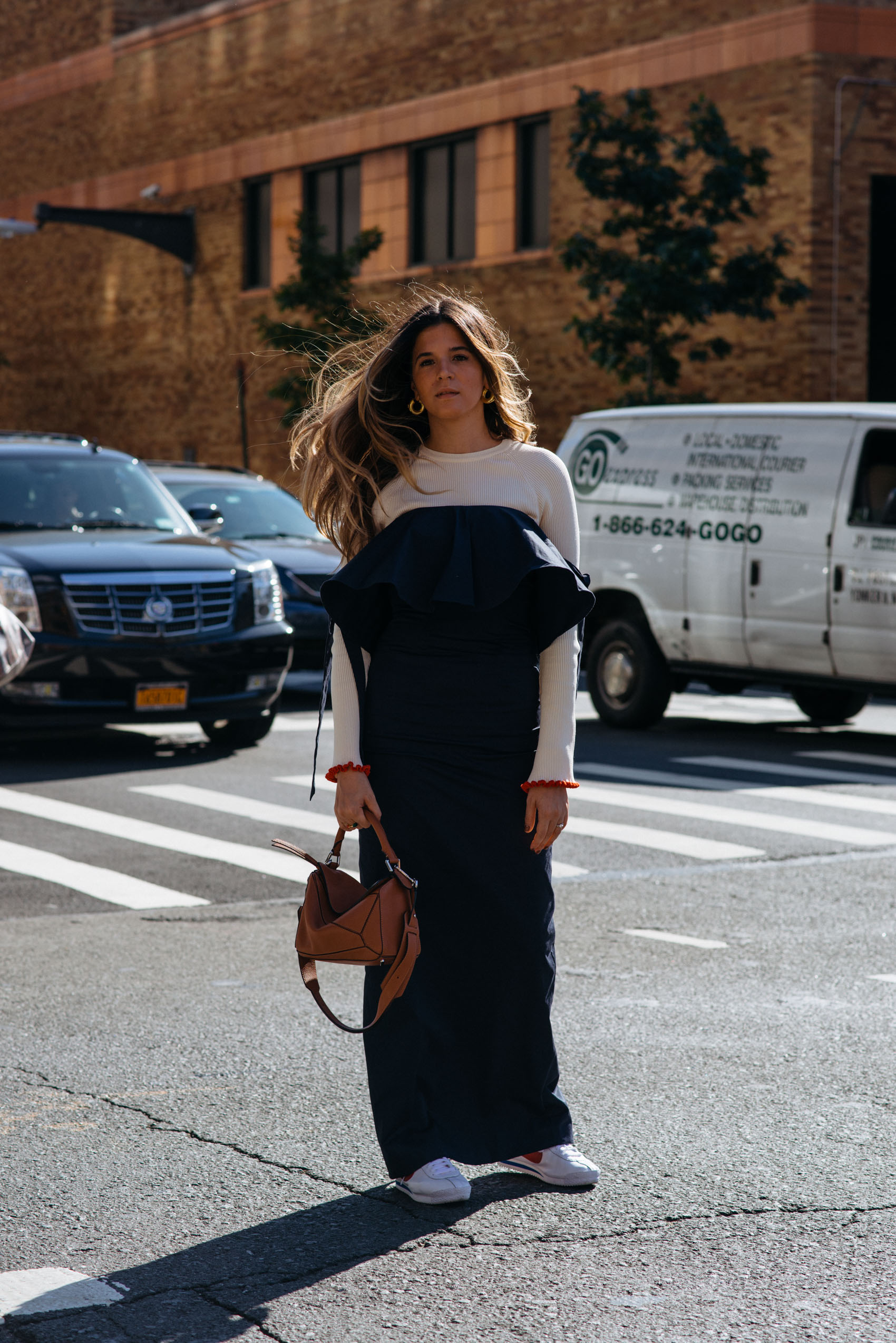 Maristella layering a sweater under a long dress with sneakers