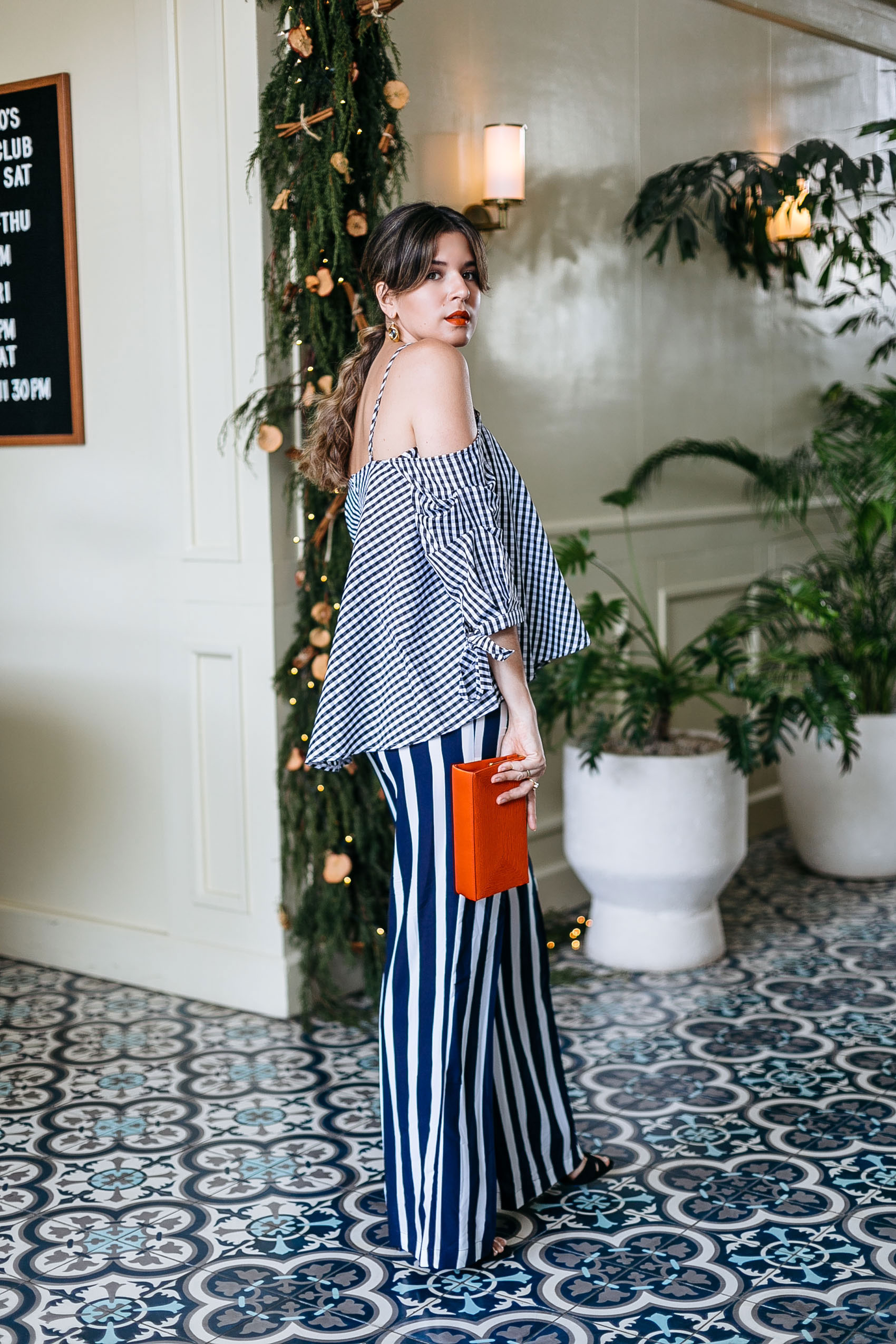 Maristella wears a loose blouse and wide leg pants for a relaxed elegant look for the holidays