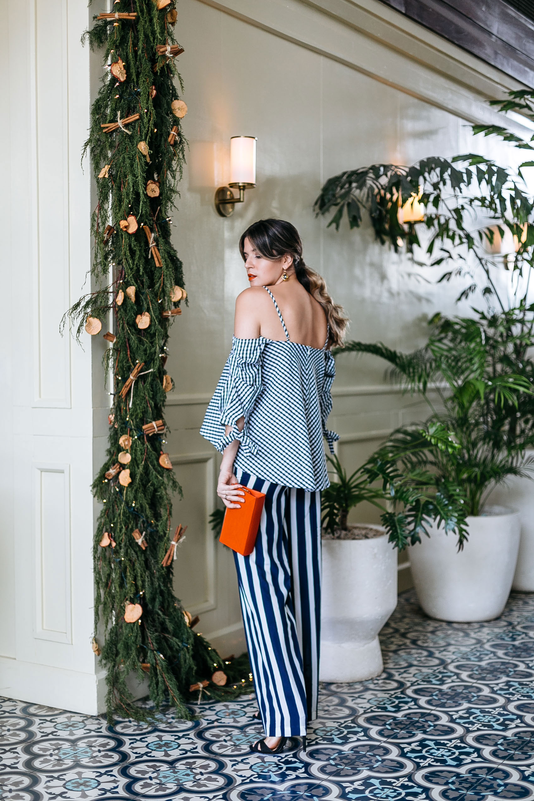 Maristella shows off her eclectic holiday print mixing with gingham and stripes