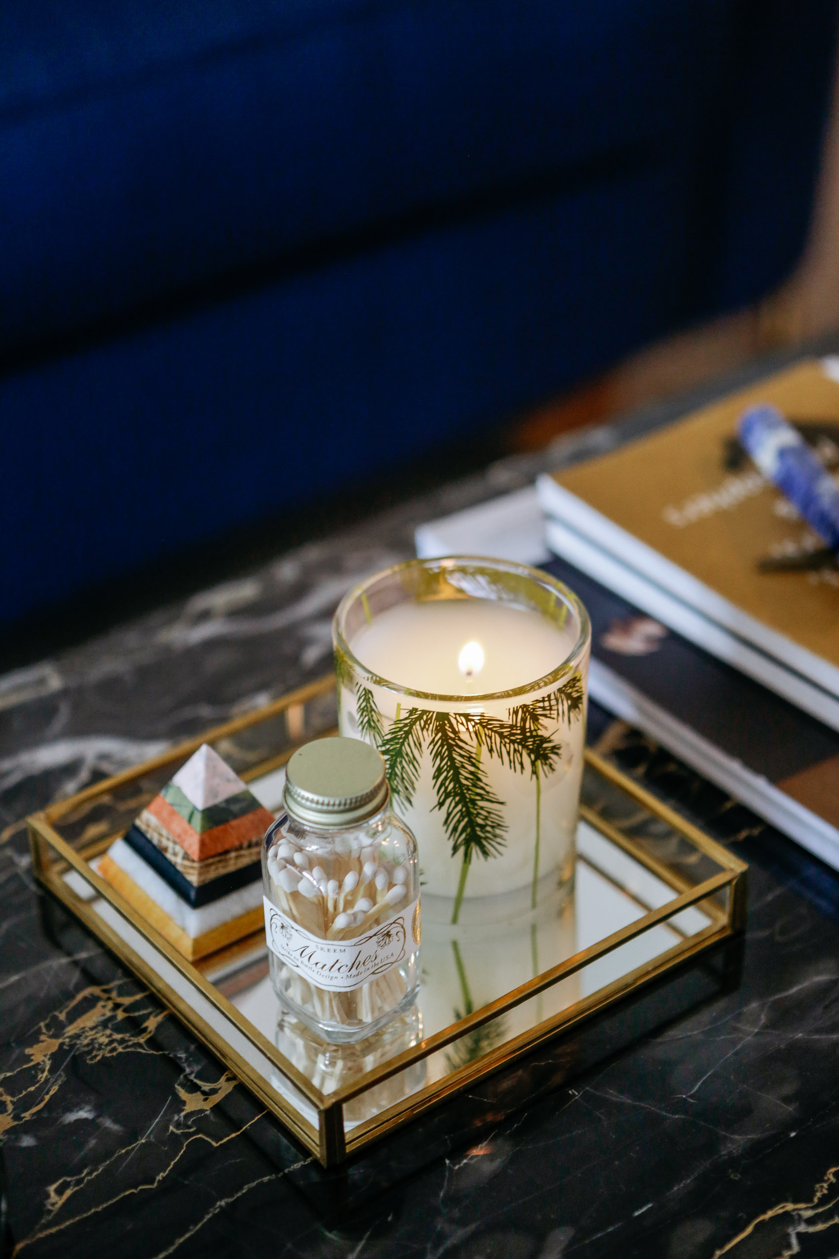 Mirrored tray decor on marble coffee table with strike on bottle matches and Thymes Frasier Fir candle