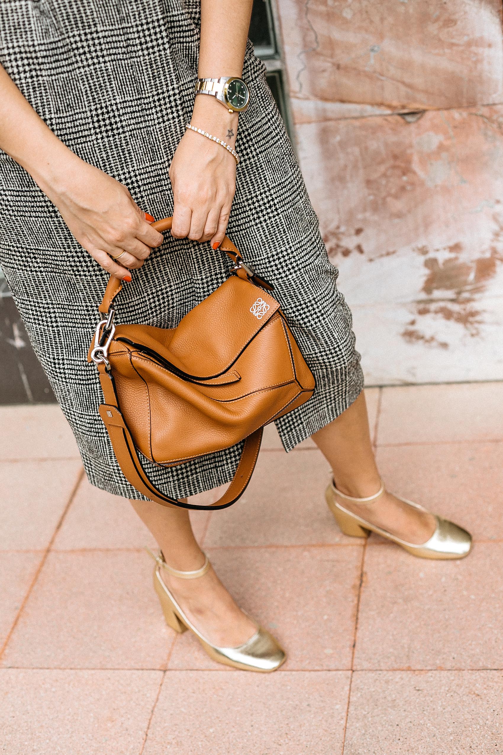 Loewe Puzzle bag in tan leather, plaid wool skirt and gold Mary Jane block heels
