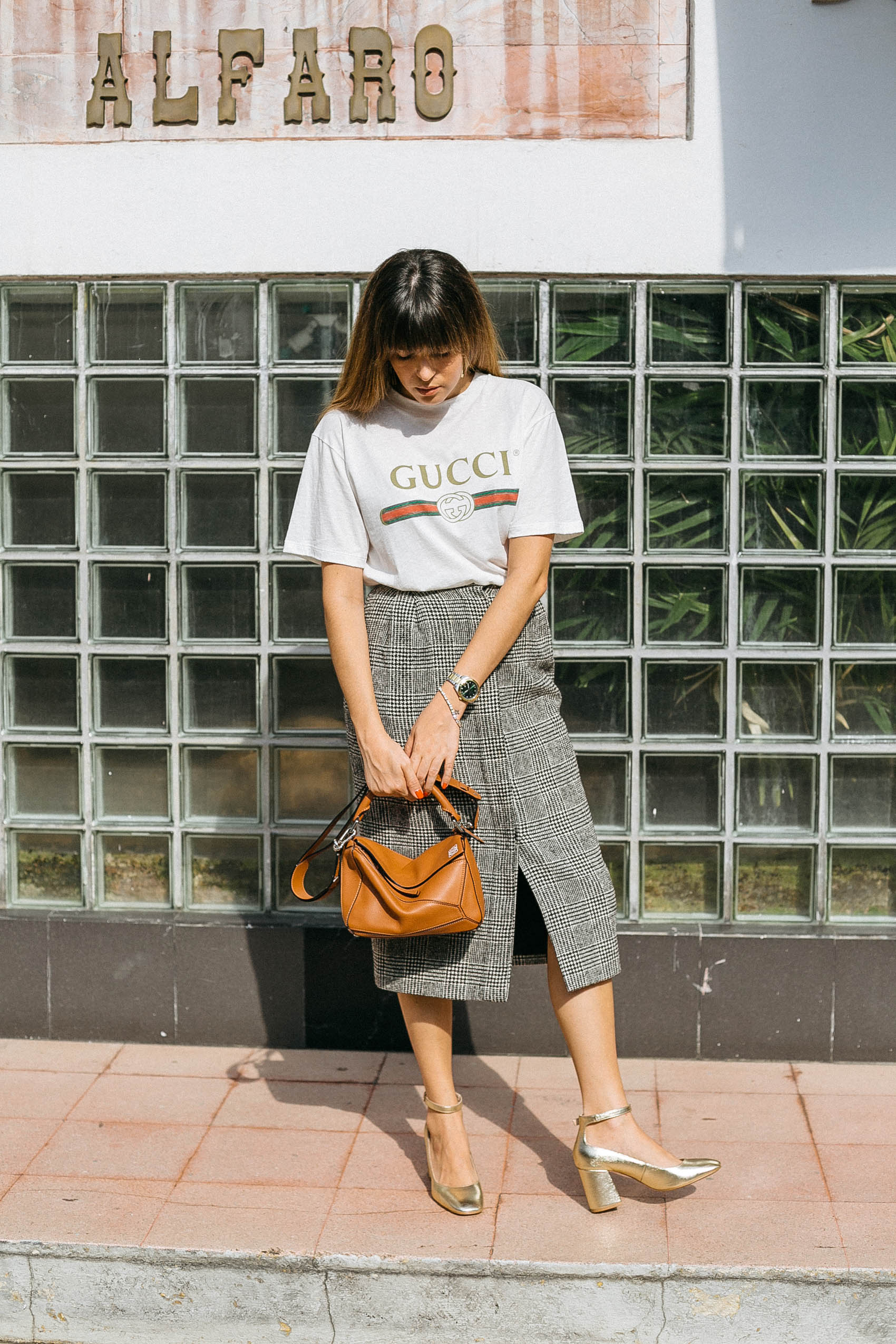Maristella wears the Gucci vintage logo tee with a plaid wool button front pencil skirt from MaxMara, Stradivarius shoes and Loewe Bag