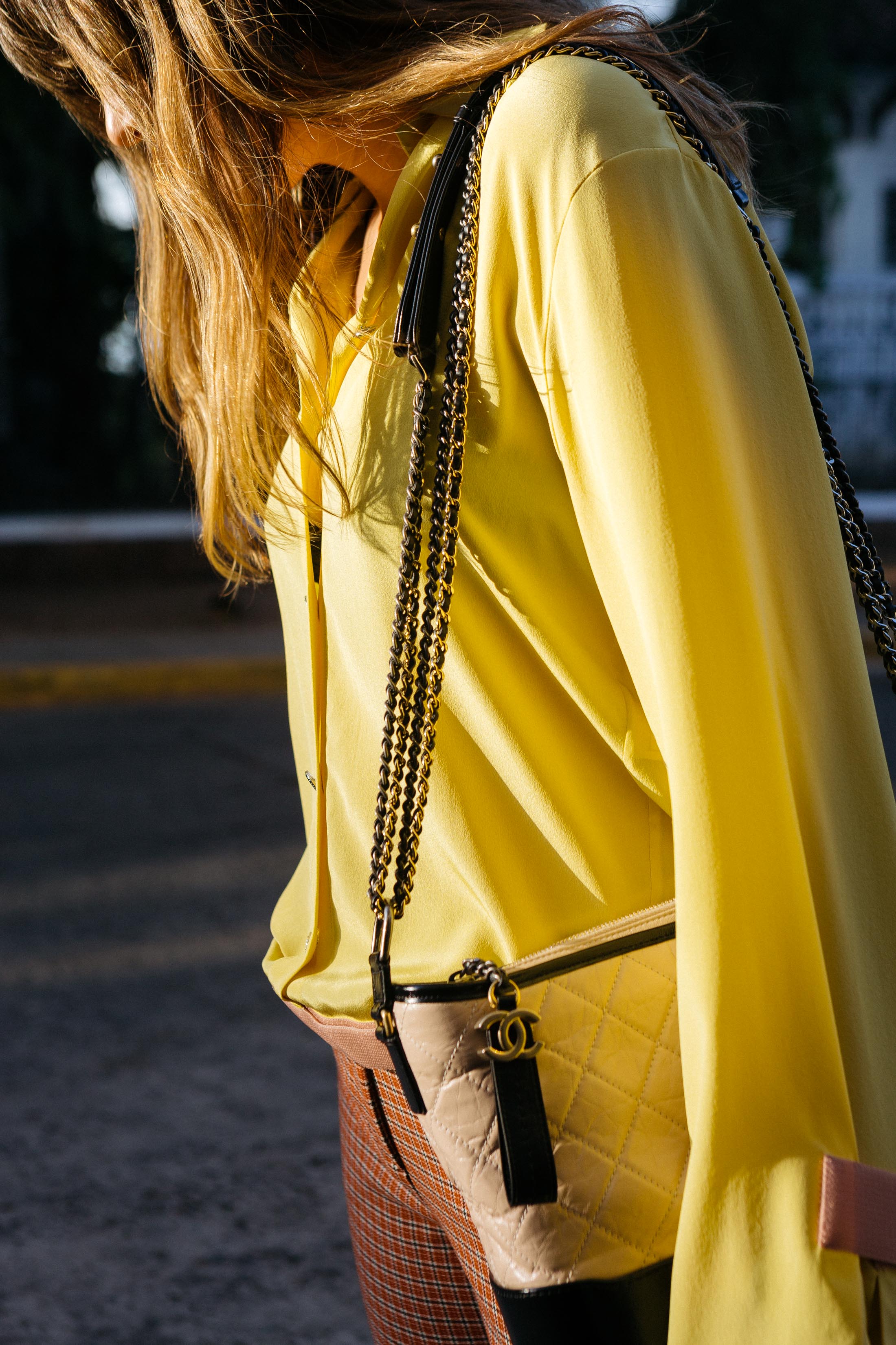 Maristella wears a Chanel Spring 2017 yellow silk blouse with the new Chanel Gabrielle shoulder bag