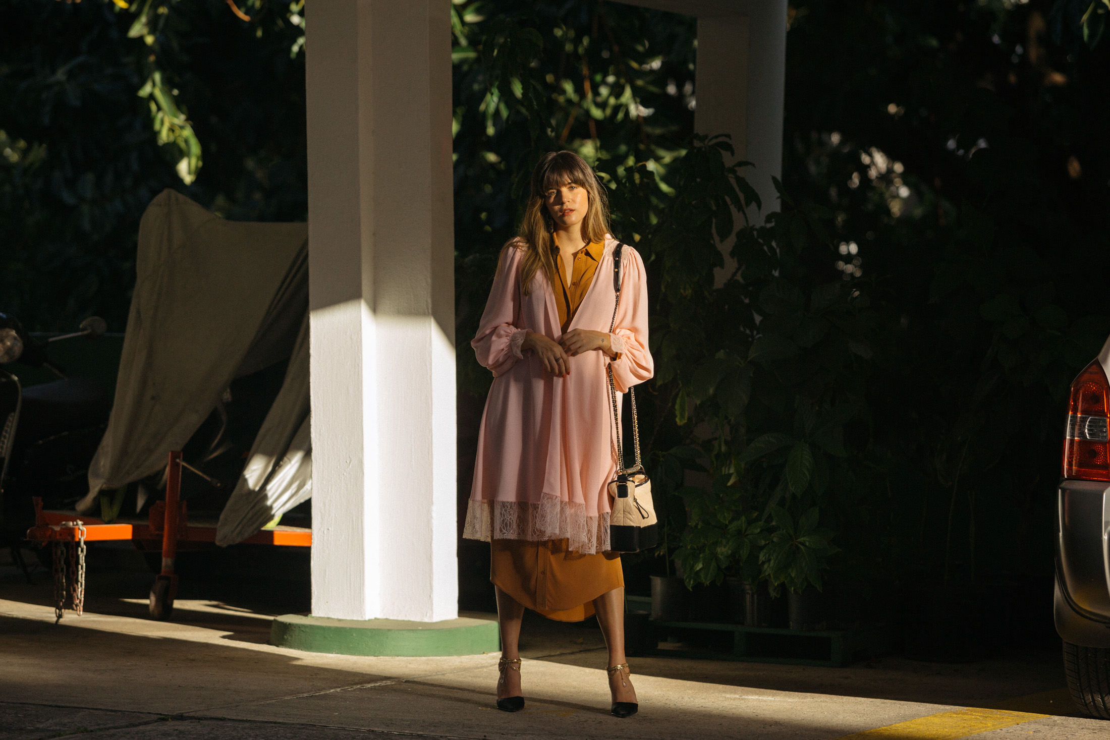 Maristella wears a pink Chanel Spring 2017 hooded robe with rust shirt dress, kitten heels and the Chanel Gabrielle bag
