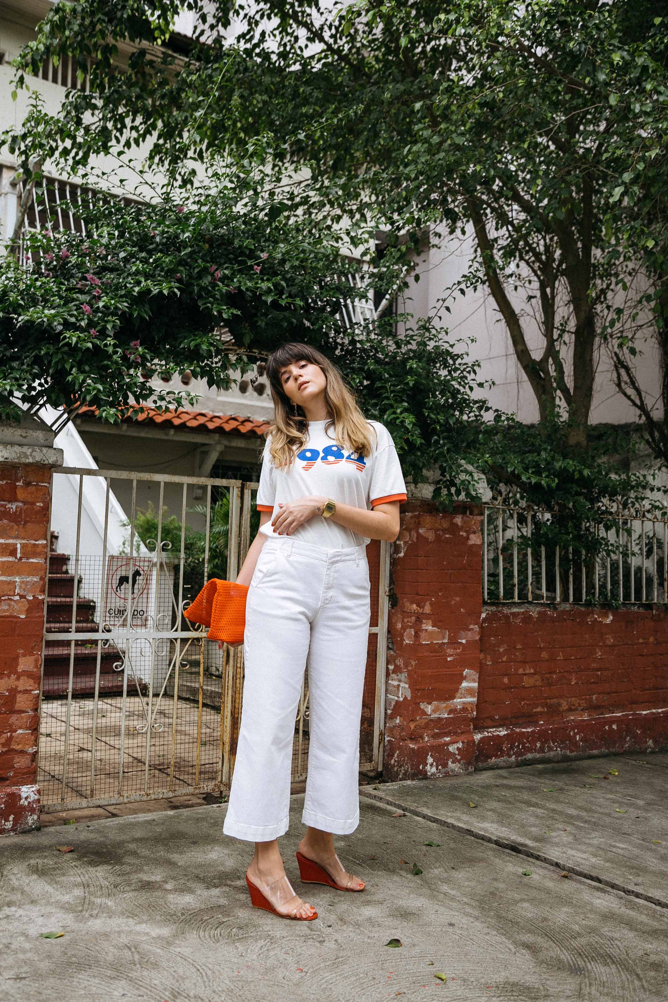 Maristella wears a nostalgic ringer tee with wide leg cropped jeans and wedge shoes
