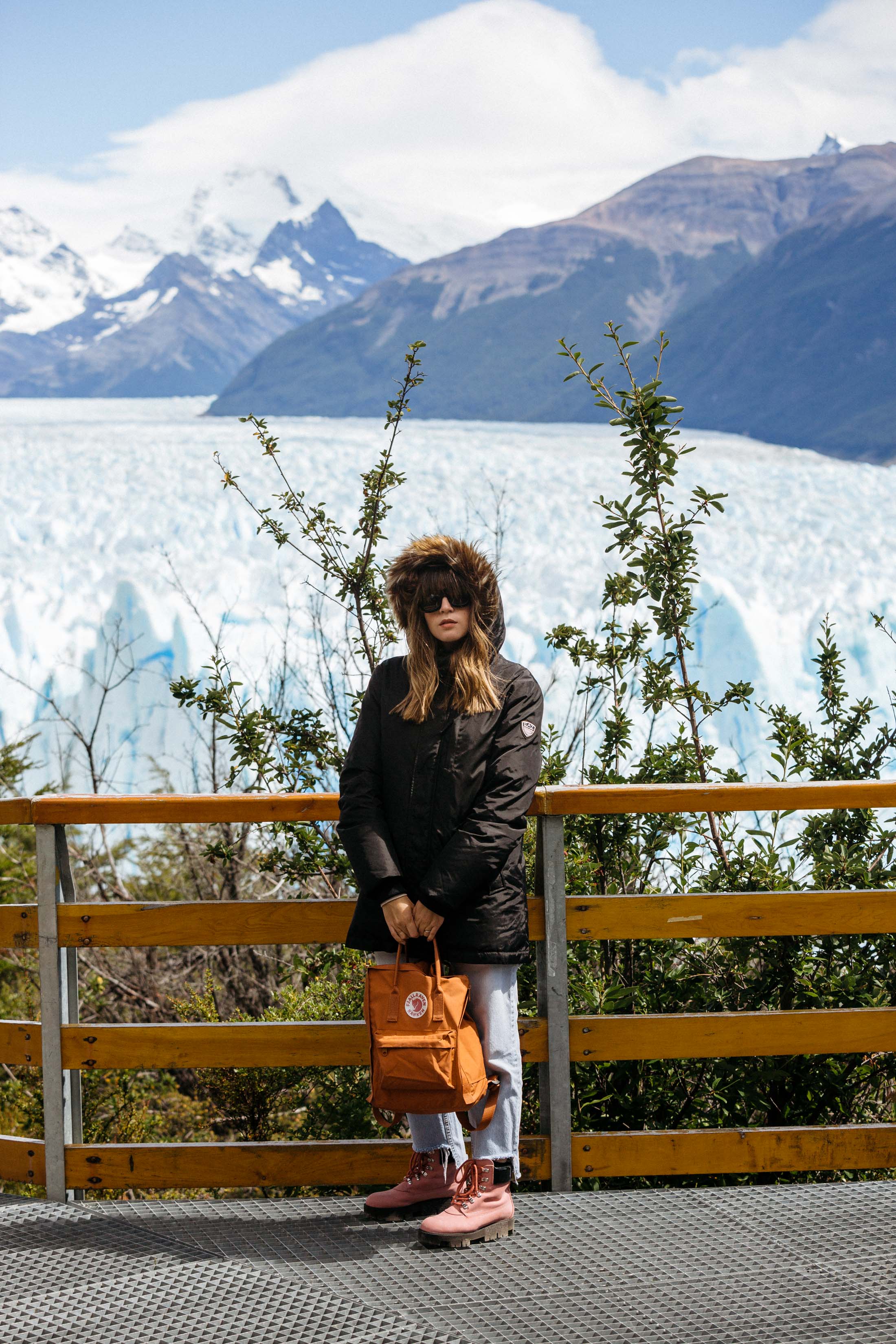 Maristella wears an Armani Parka and Fjallraven backpack at the Perito Moreno Glacier