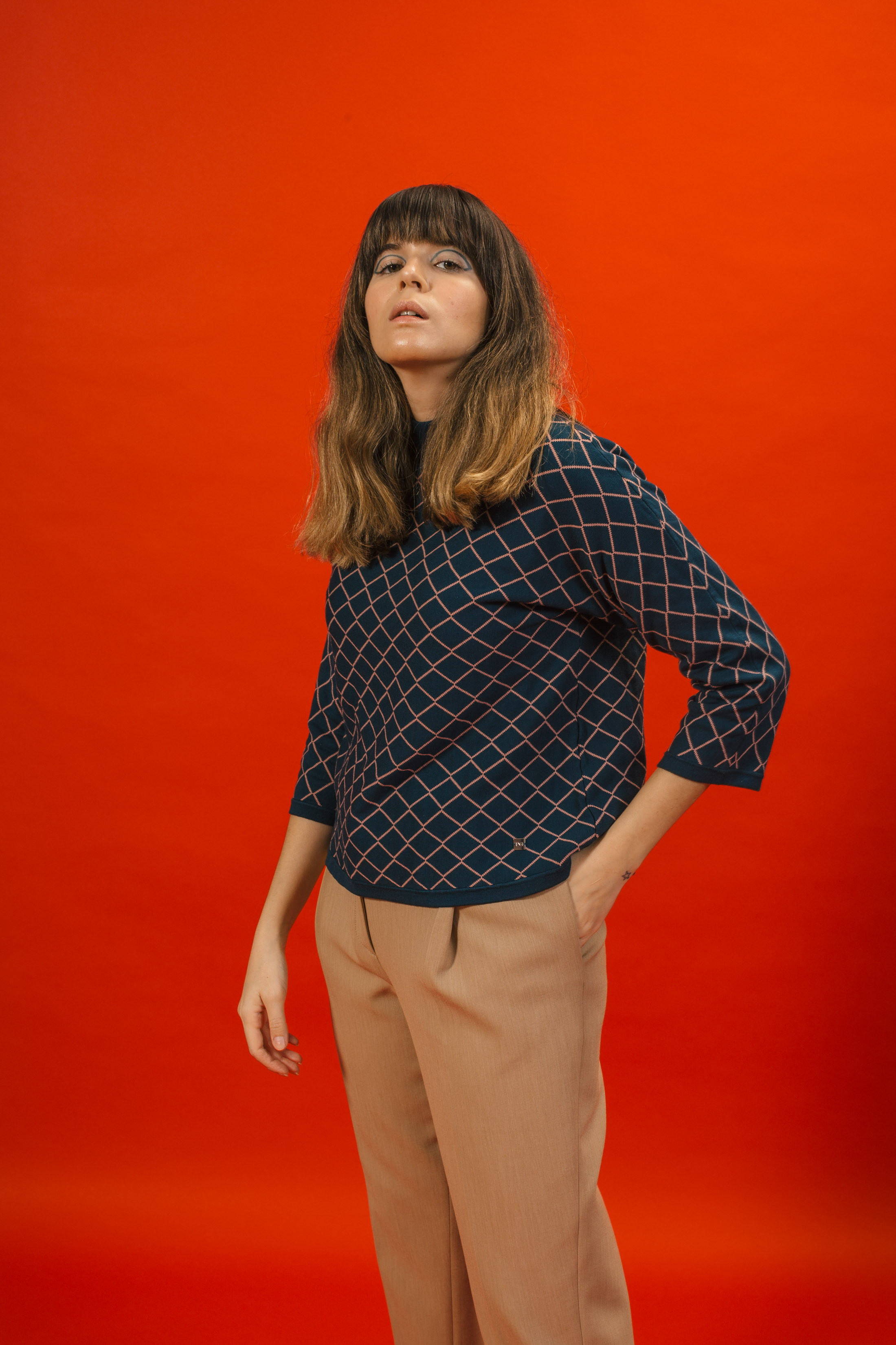 Maristella wears a knit sweater and pants from Purificación García