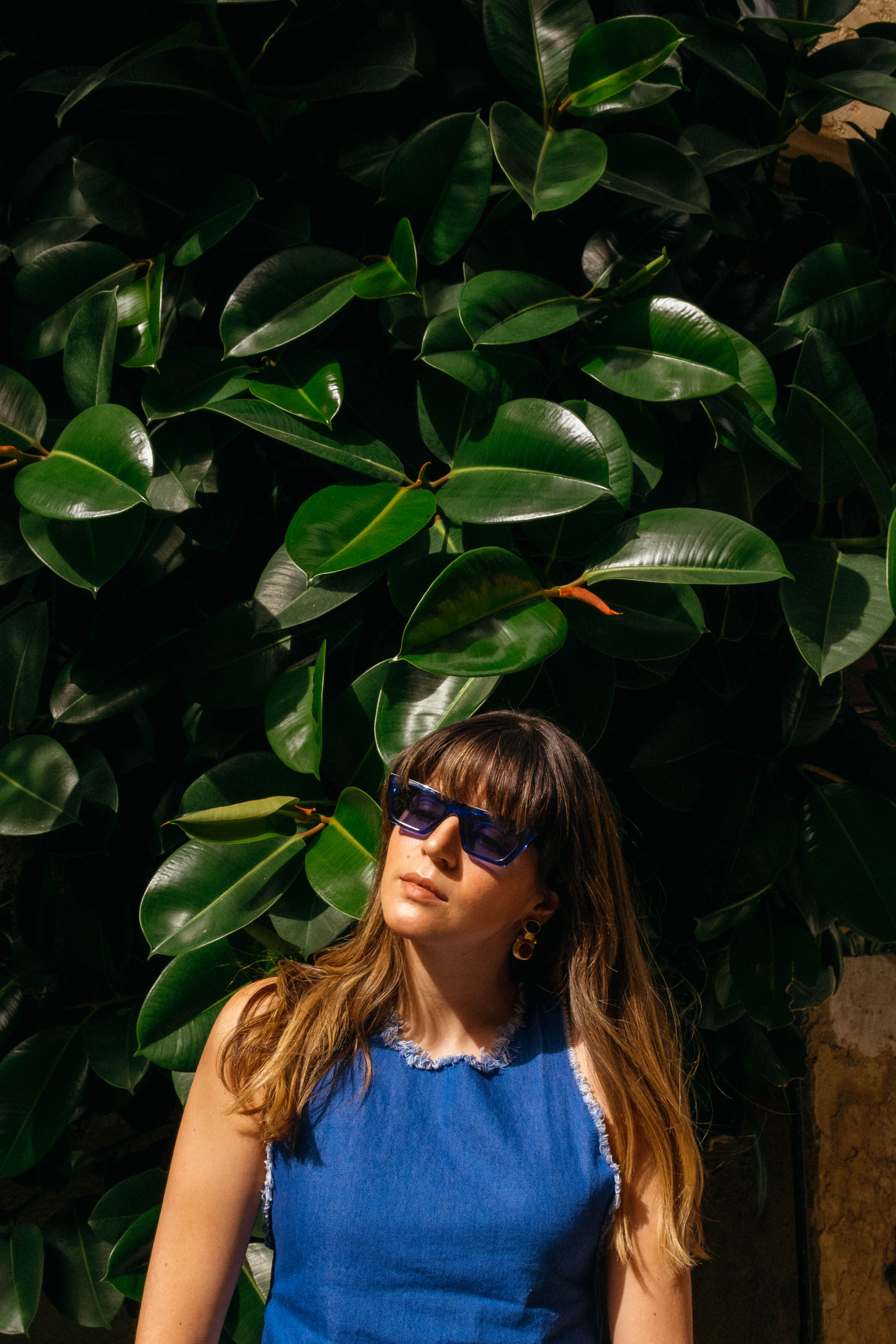 Maristella wearing a Zara denim top, Mango blue sunglasses in Saint Paul de Vence, France