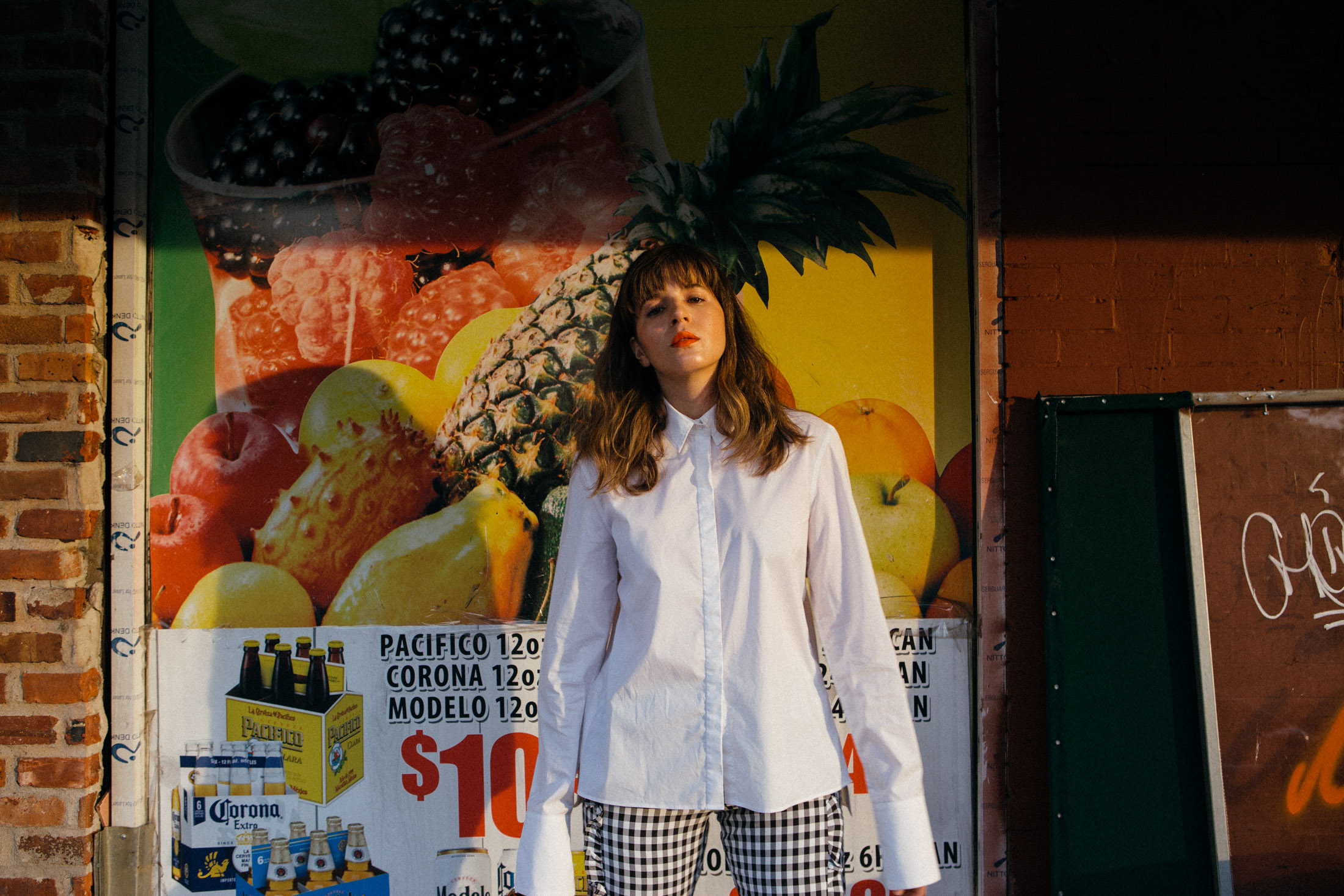 Maristella wears Gingham pants from Alpha and Omega with an H&M Studio white shirt