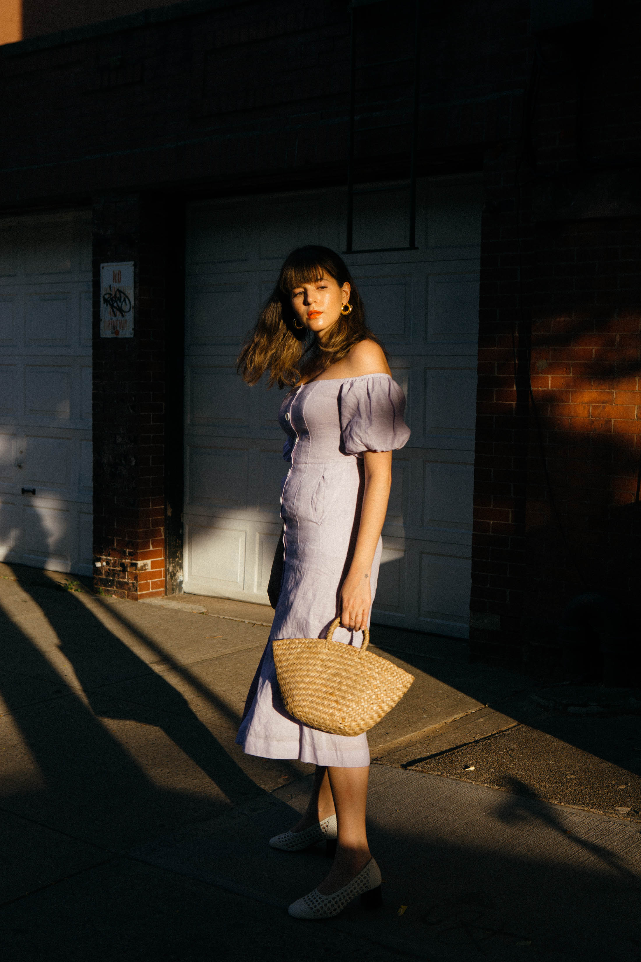 Maristella wears a lilac linen off the shoulder dress from Kitri Studio