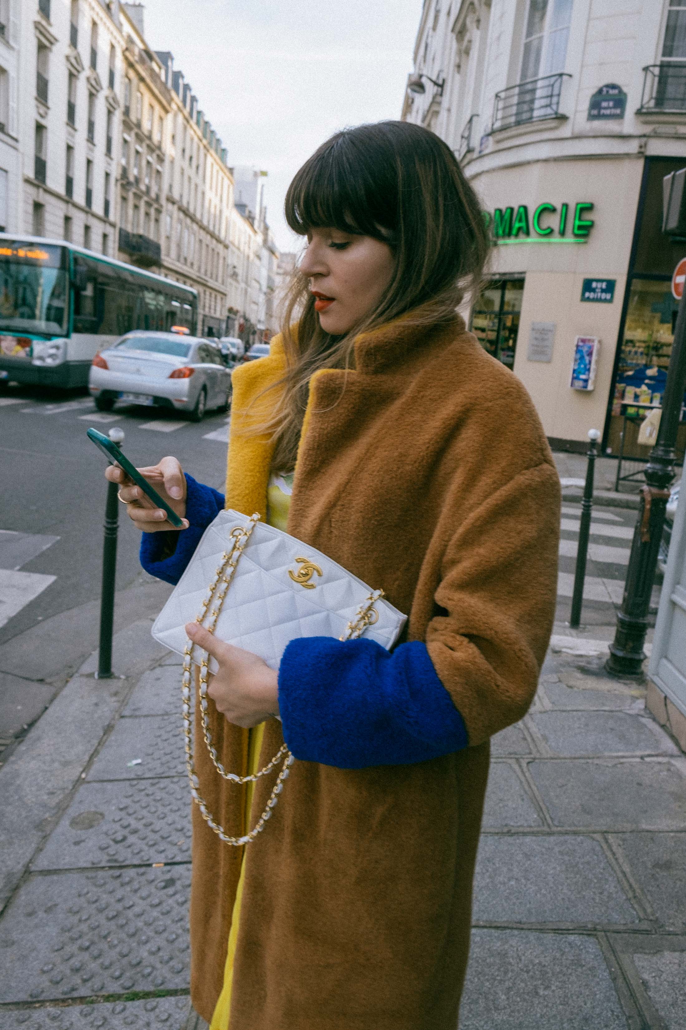 Maristella wears a coat from Mango and vintage white Chanel bag in Le Marais Paris