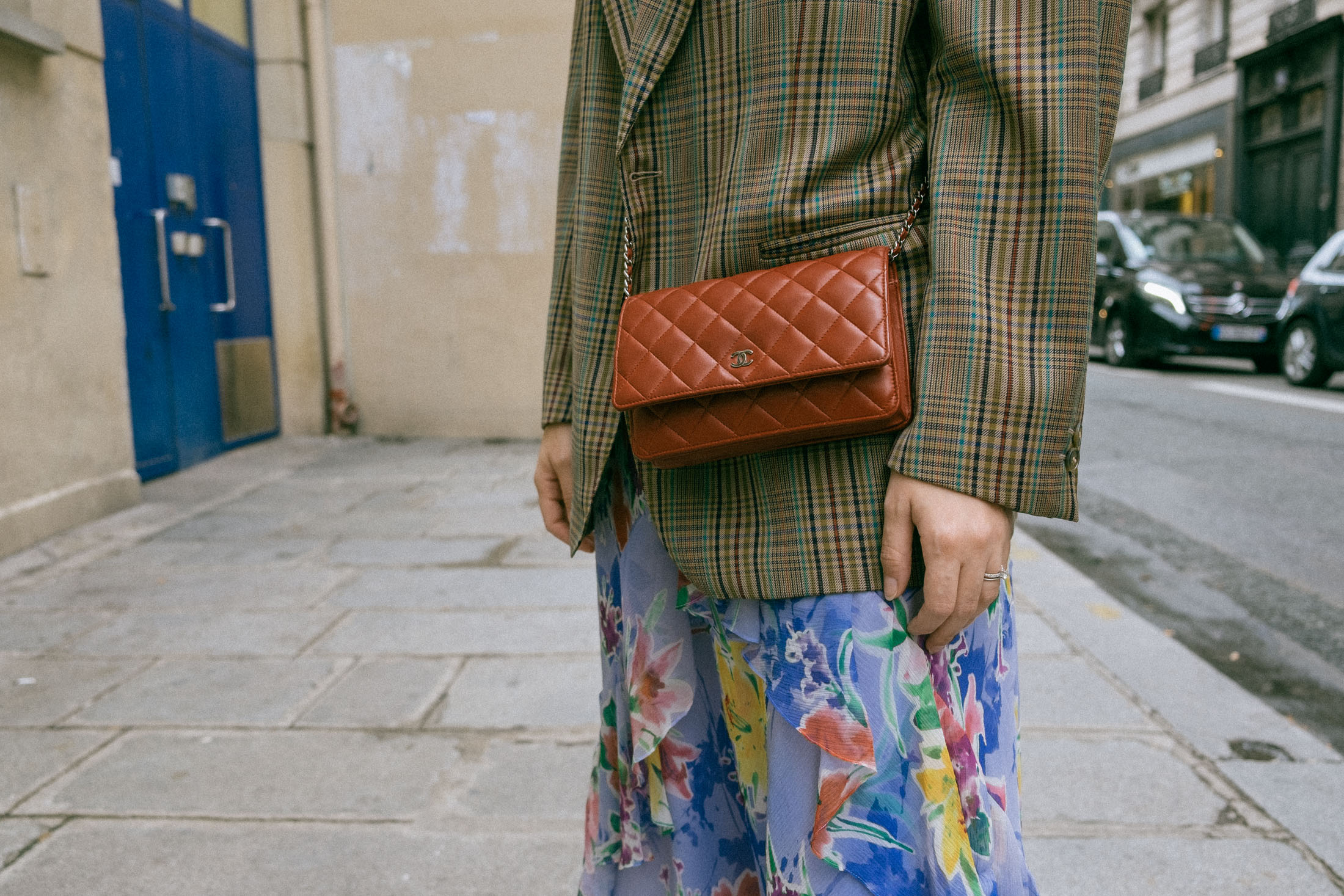 Maristella wears a vintage men's blazer, vintage floral dress, Loeffler Randall silver boots and mini burgundy Chanel crossbody bag in Paris
